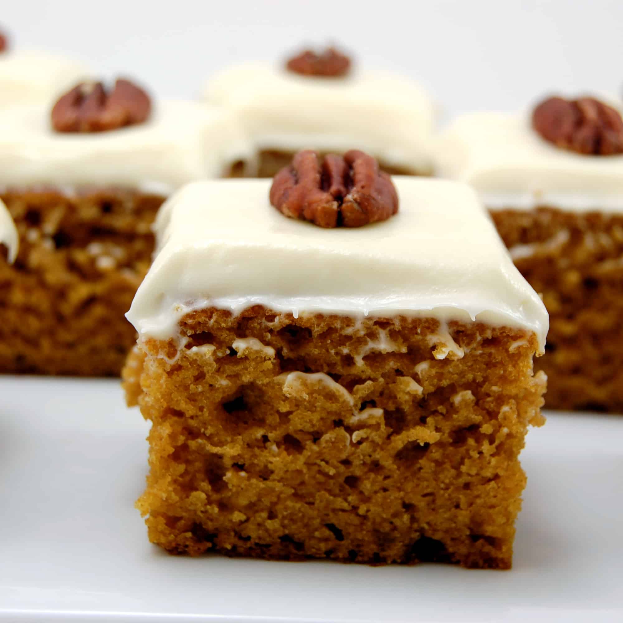 pumpkin bar with cream cheese frosting with a walnut on top