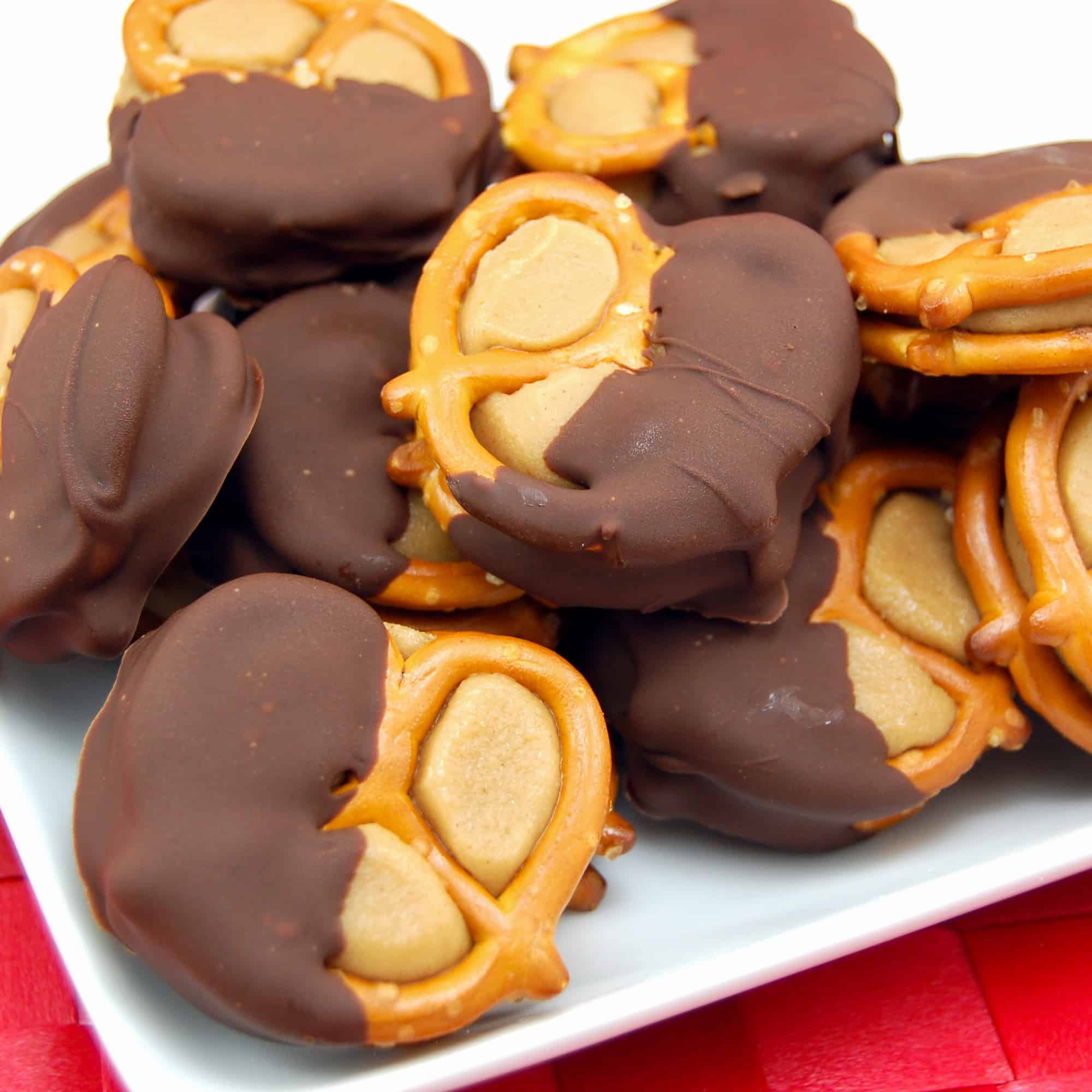 buckeye peanut butter pretzels on a white plate with a red mat