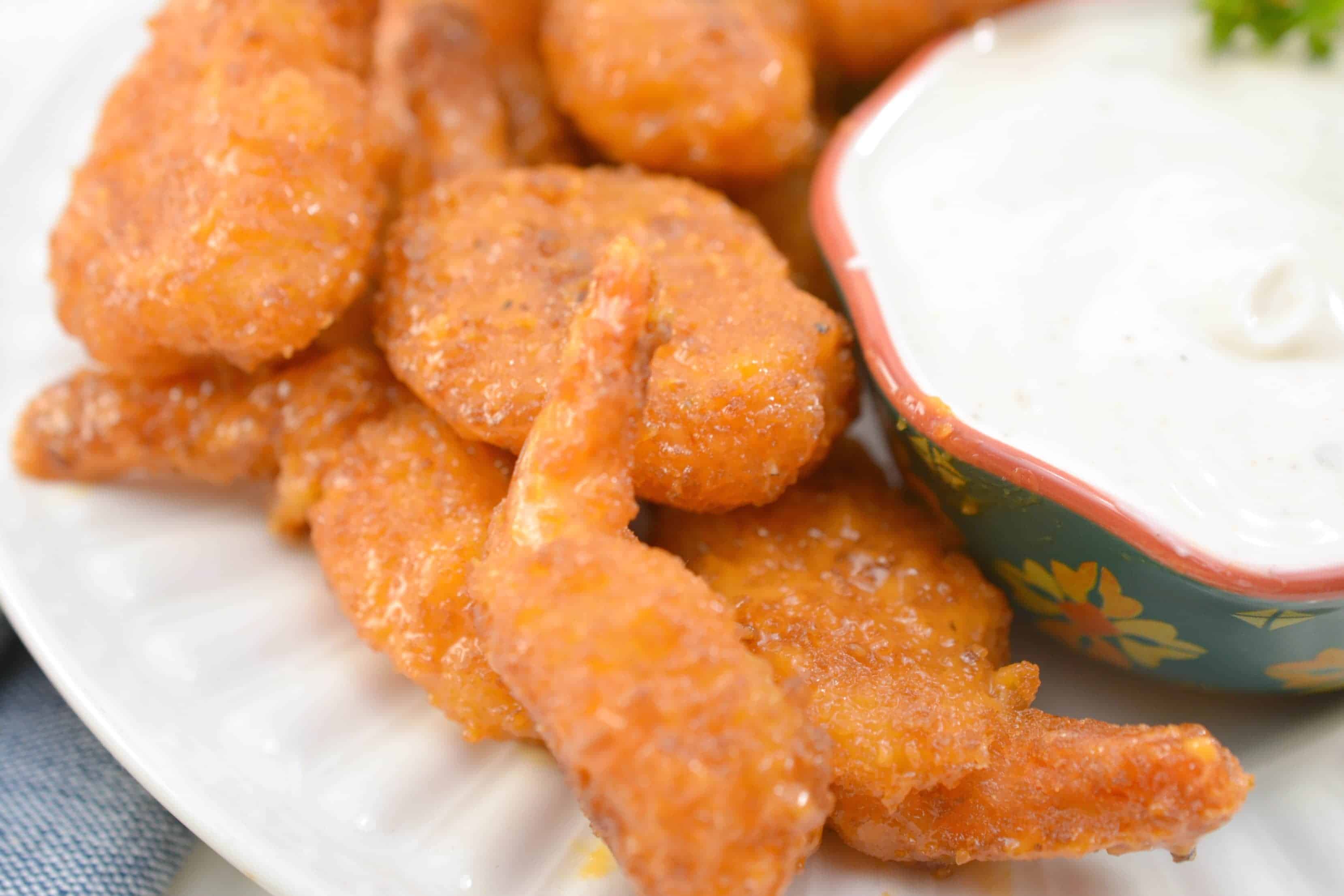 Buffalo Shrimp on a plate with dipping sauce 