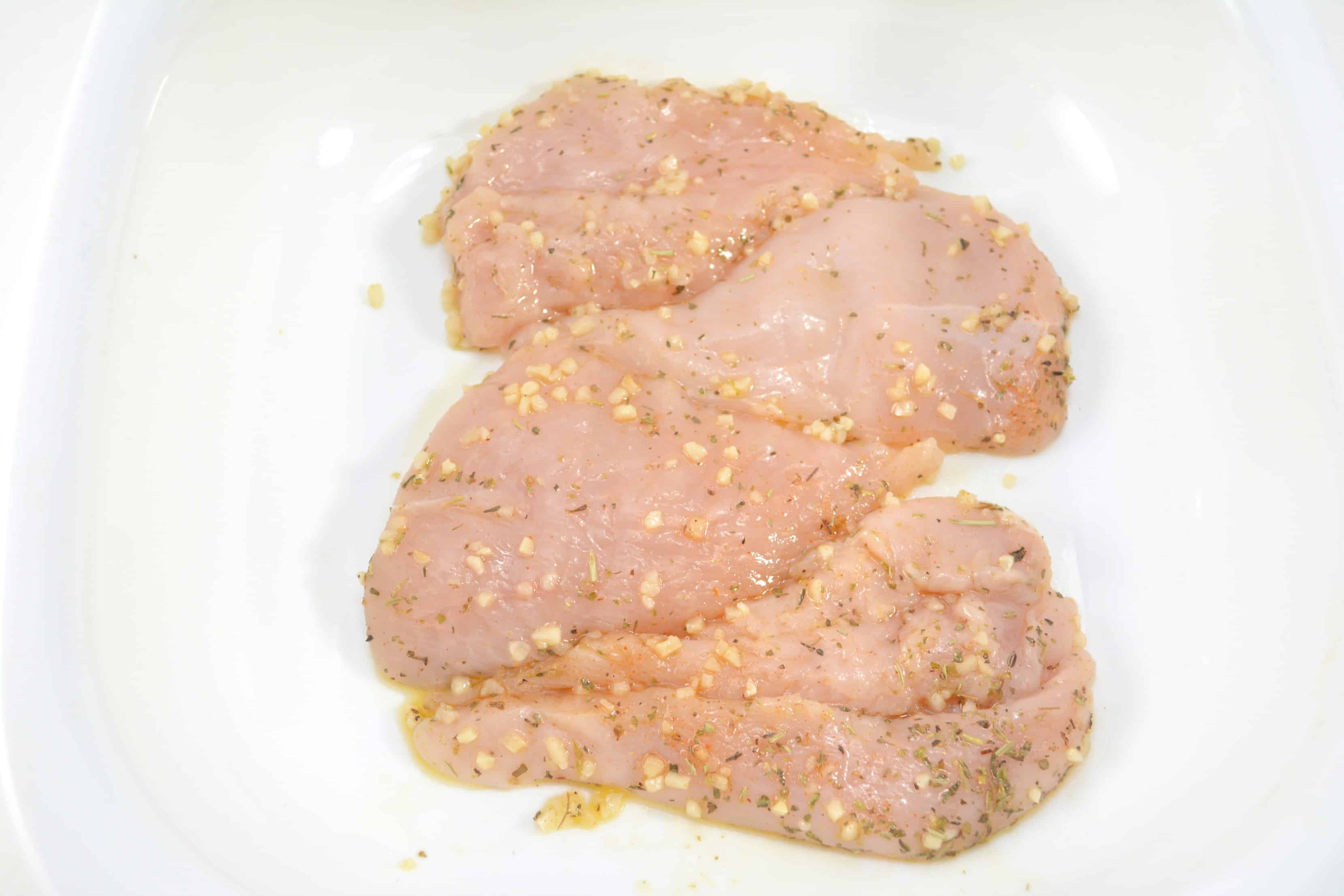 seasoned chicken breasts in a casserole dish