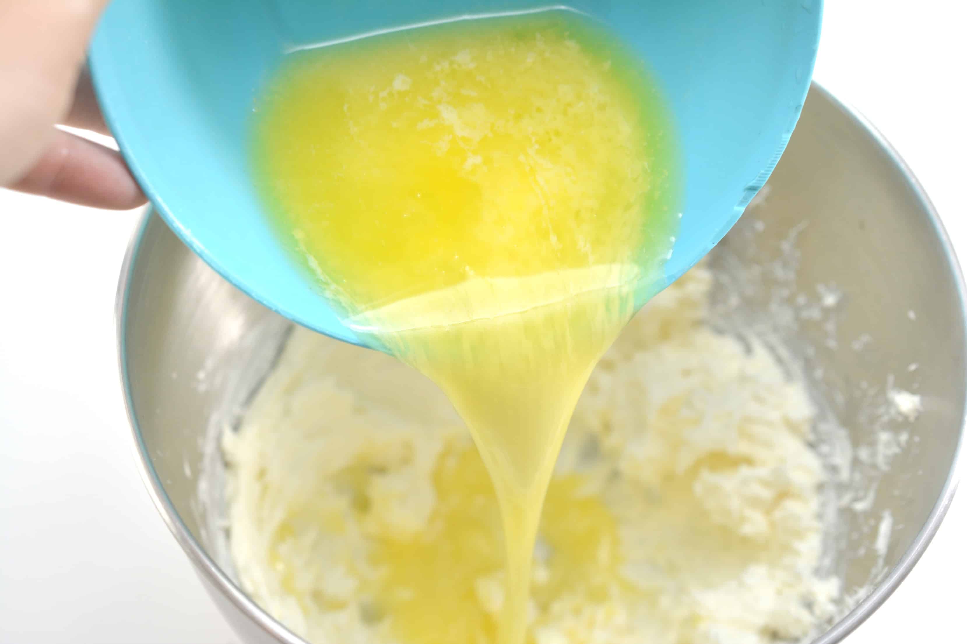 melted butter being poured into a bowl