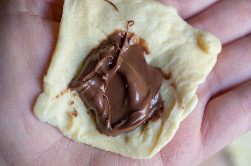 crescent roll with a spoonful of Nutella in center