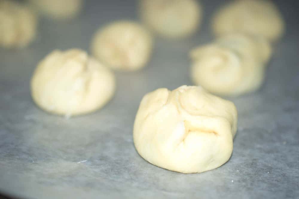 crescent roll dough stuffed with nutella on parchment paper