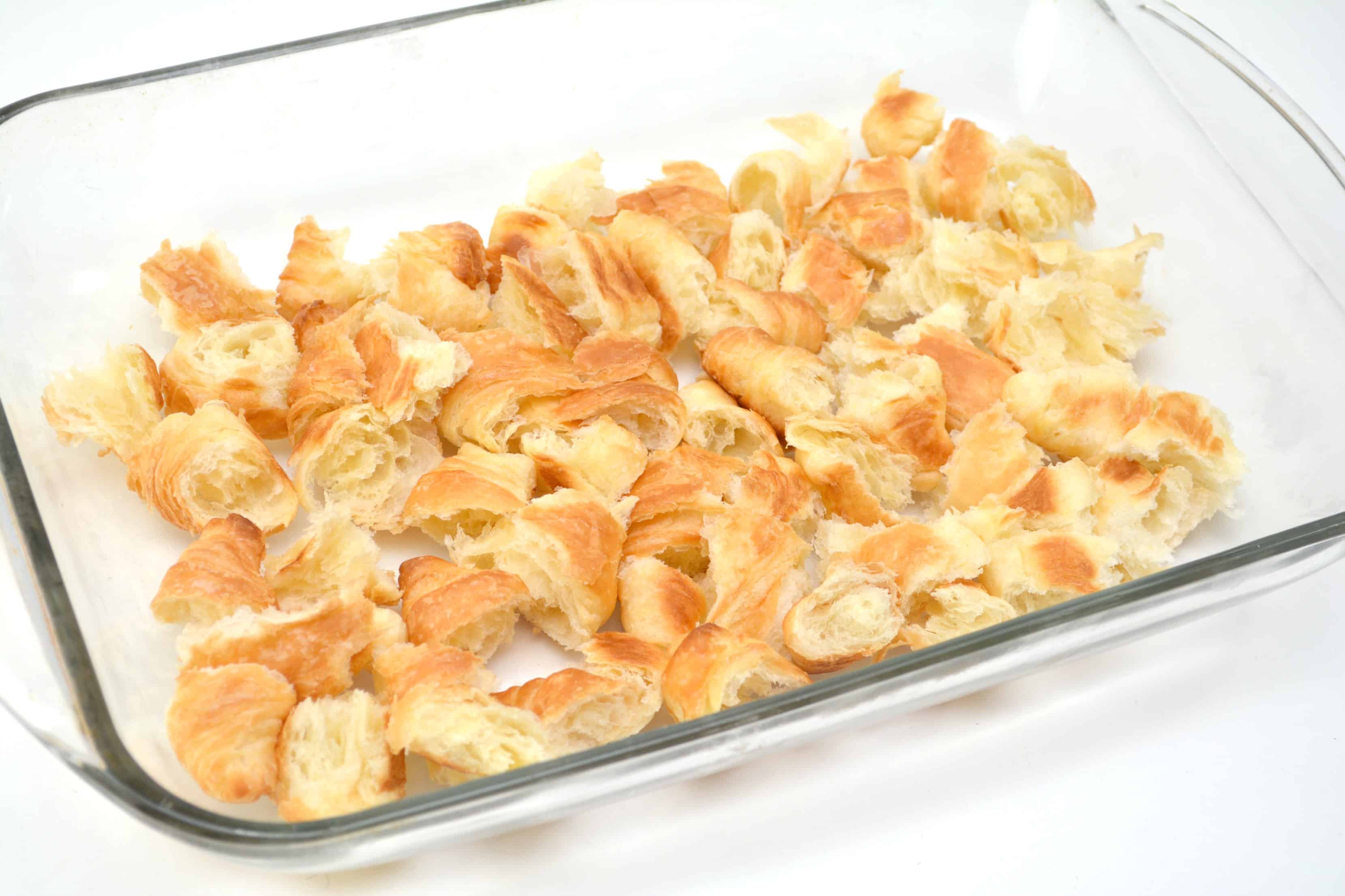 torn pieces of Croissants in a casserole dish