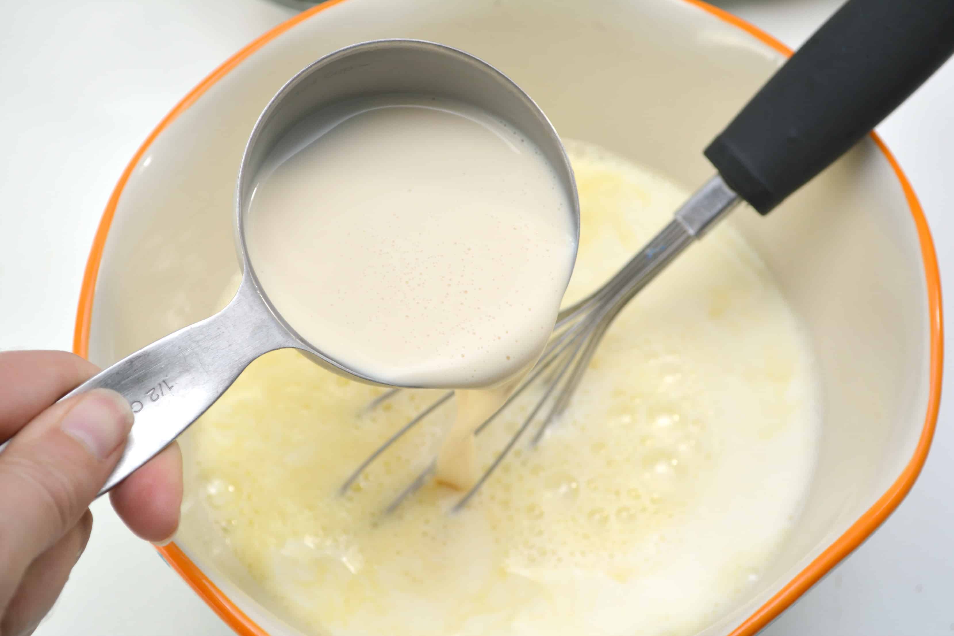 pouring cream in egg mixture