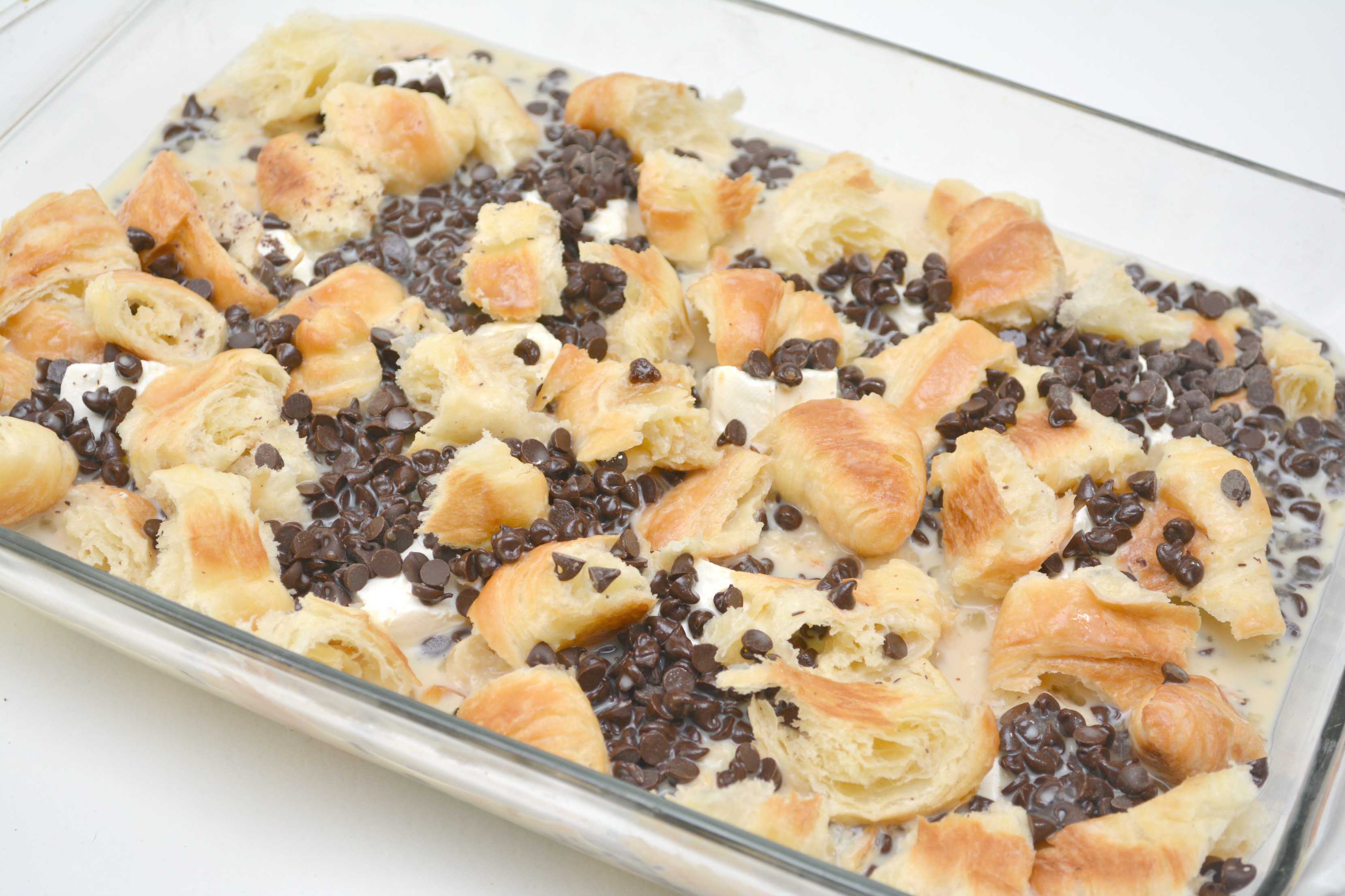 Croissants, chocolate chips and filling in a baking dish