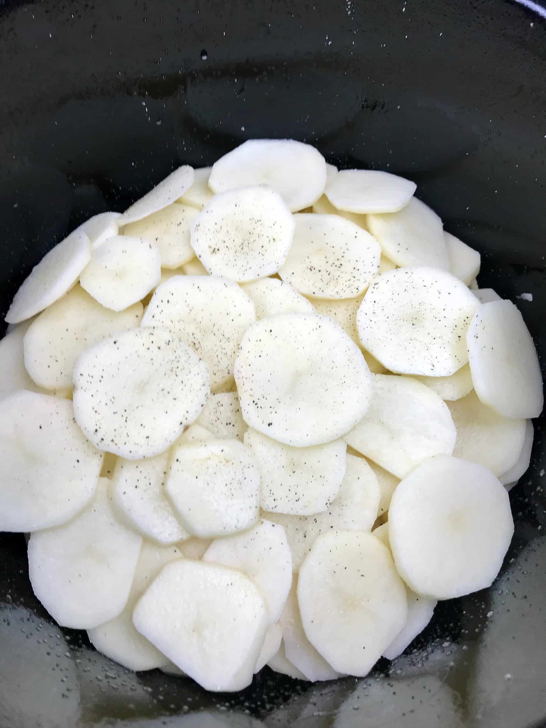 potatoes layered in bottom of slow cooker 