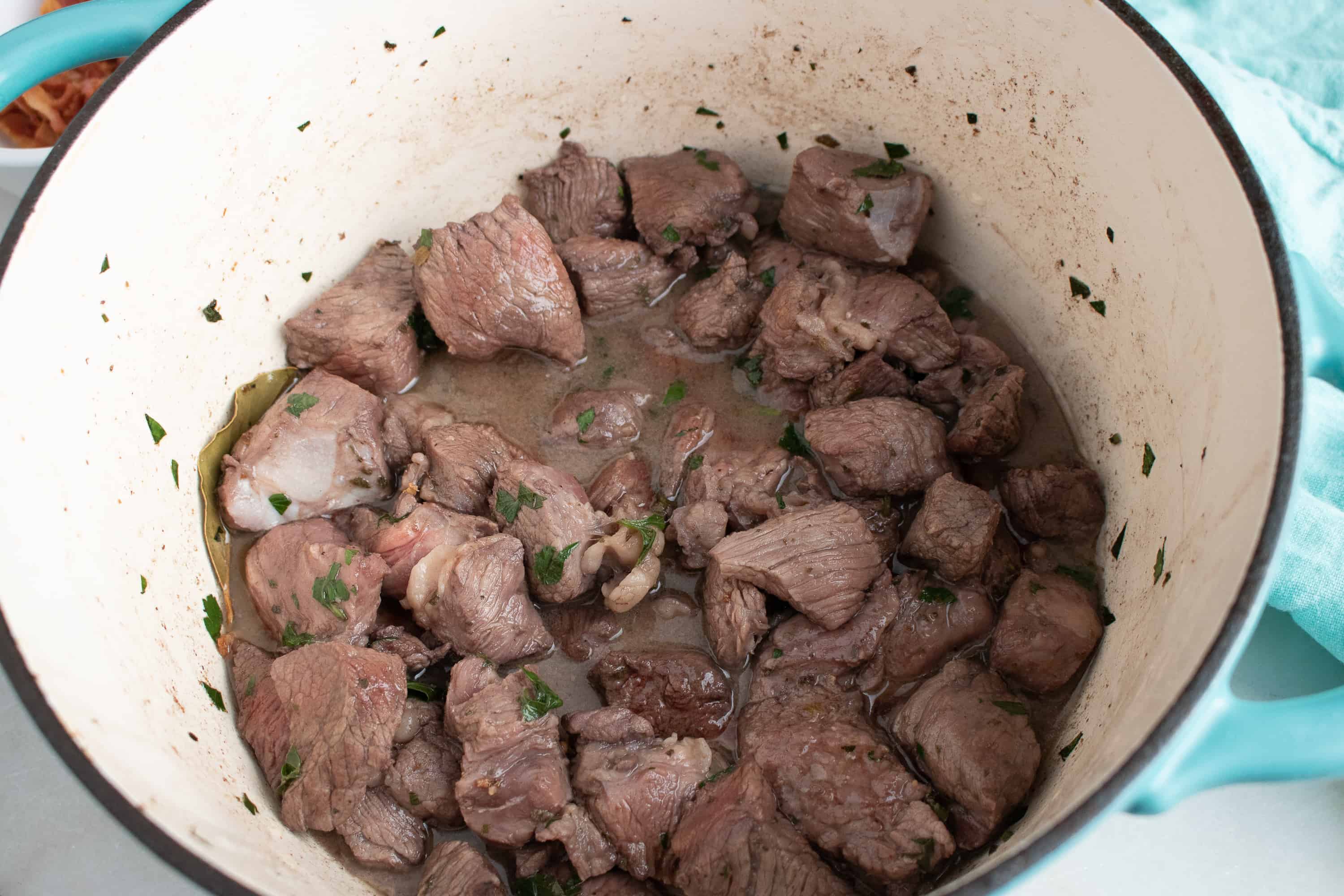 browned stew meat in a white bowl