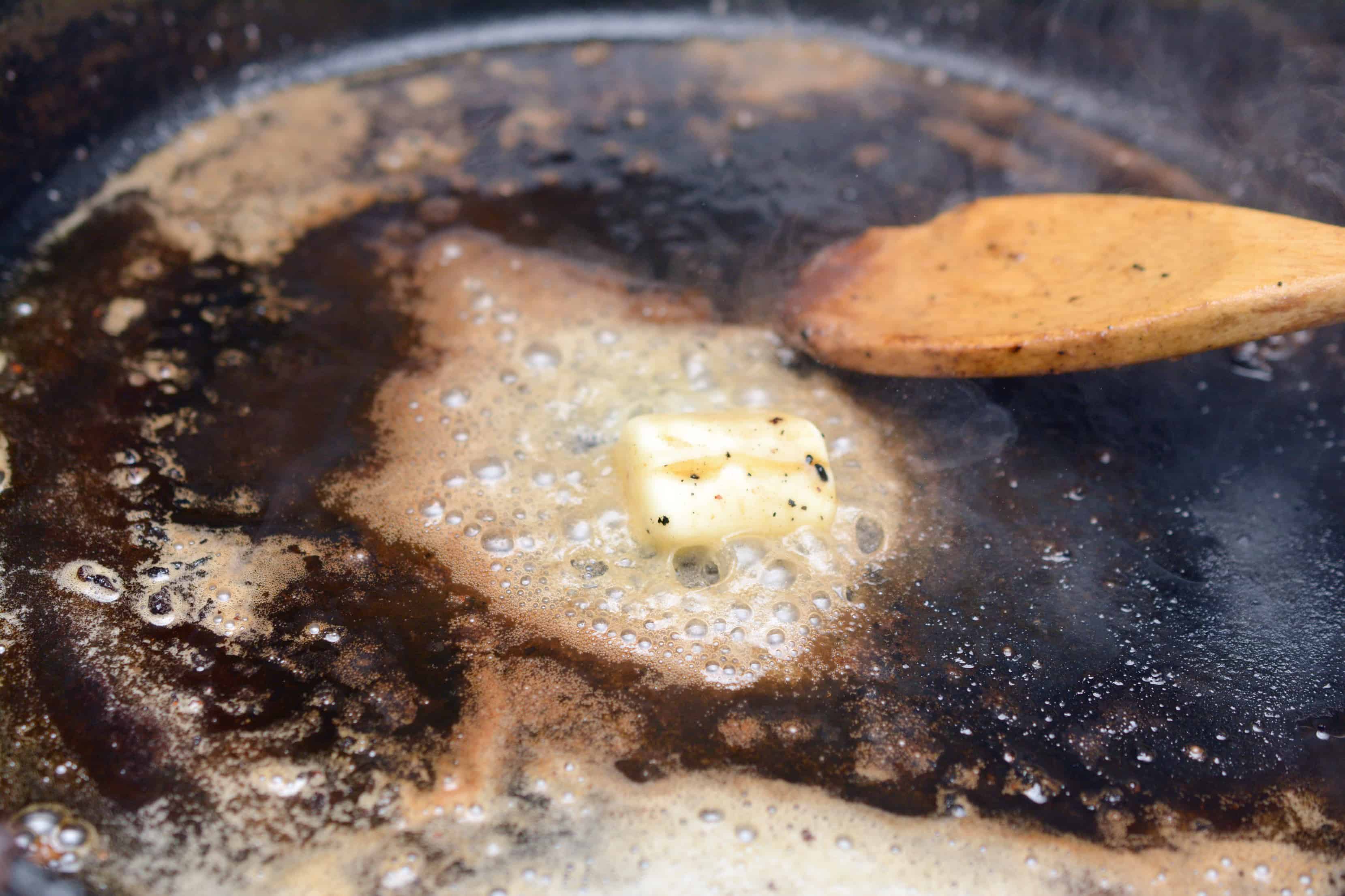 butter melting in a cast iron pan
