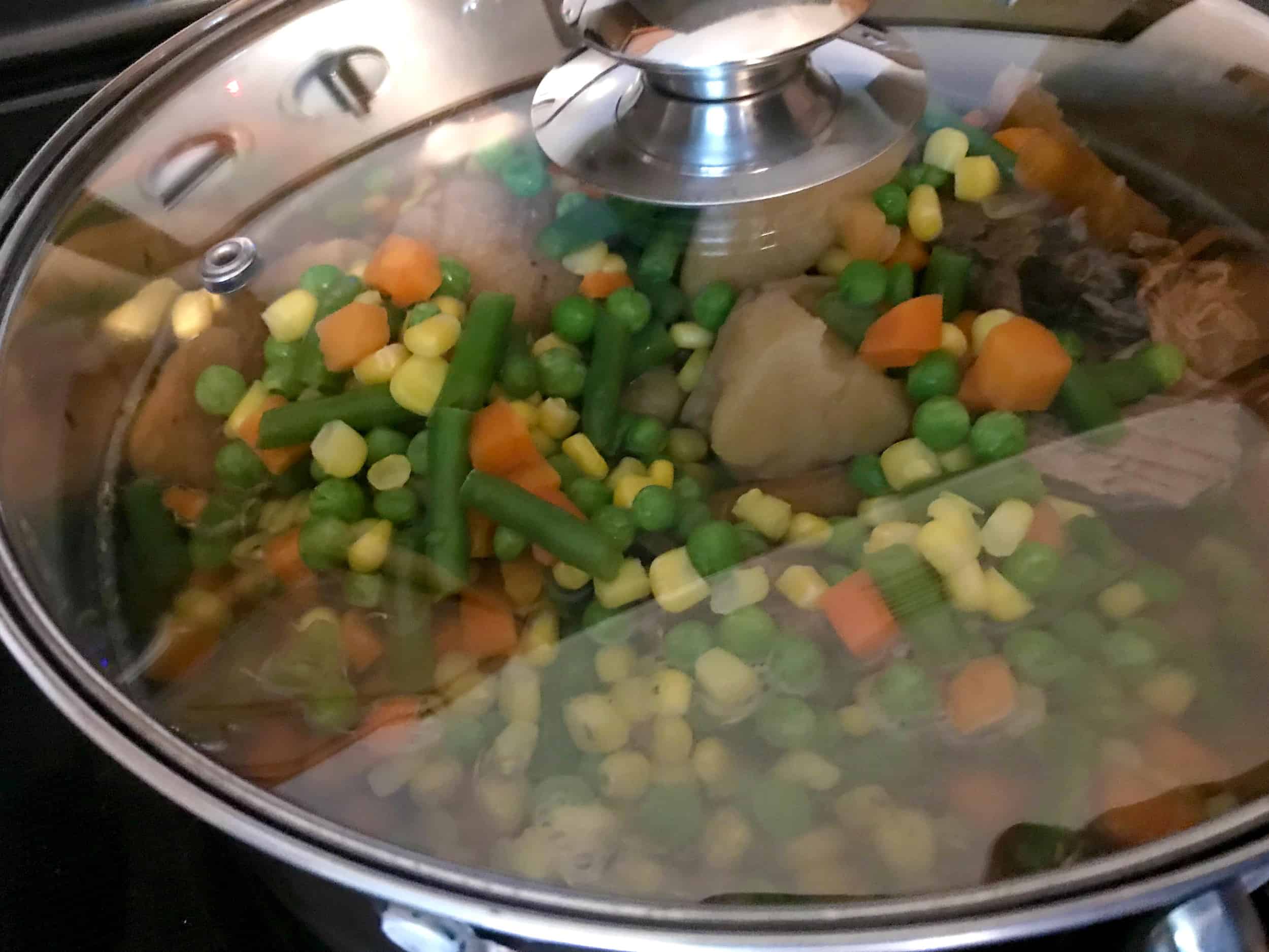 beef stew on stovetop with lid