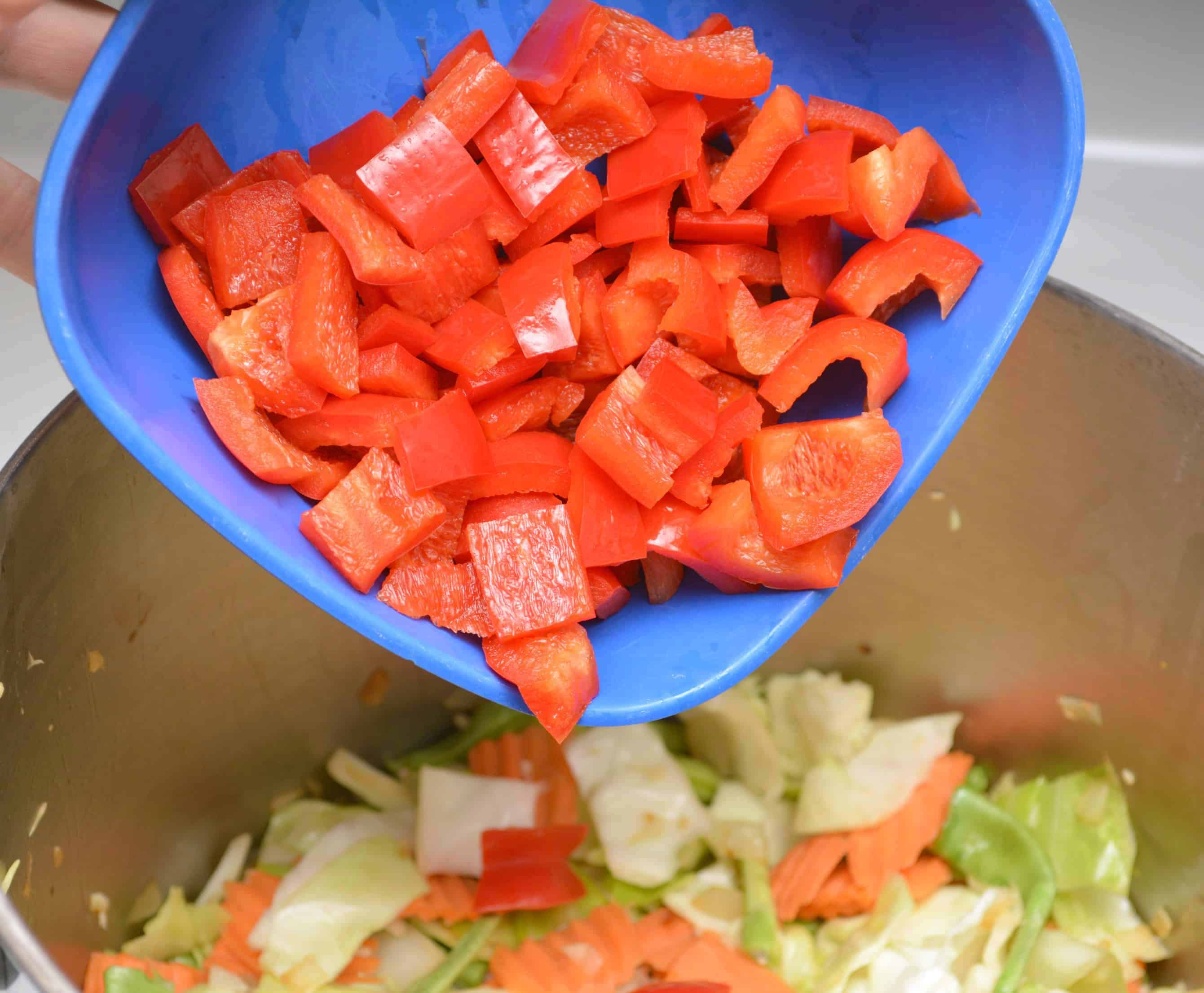 peppers going into cabbage soup 