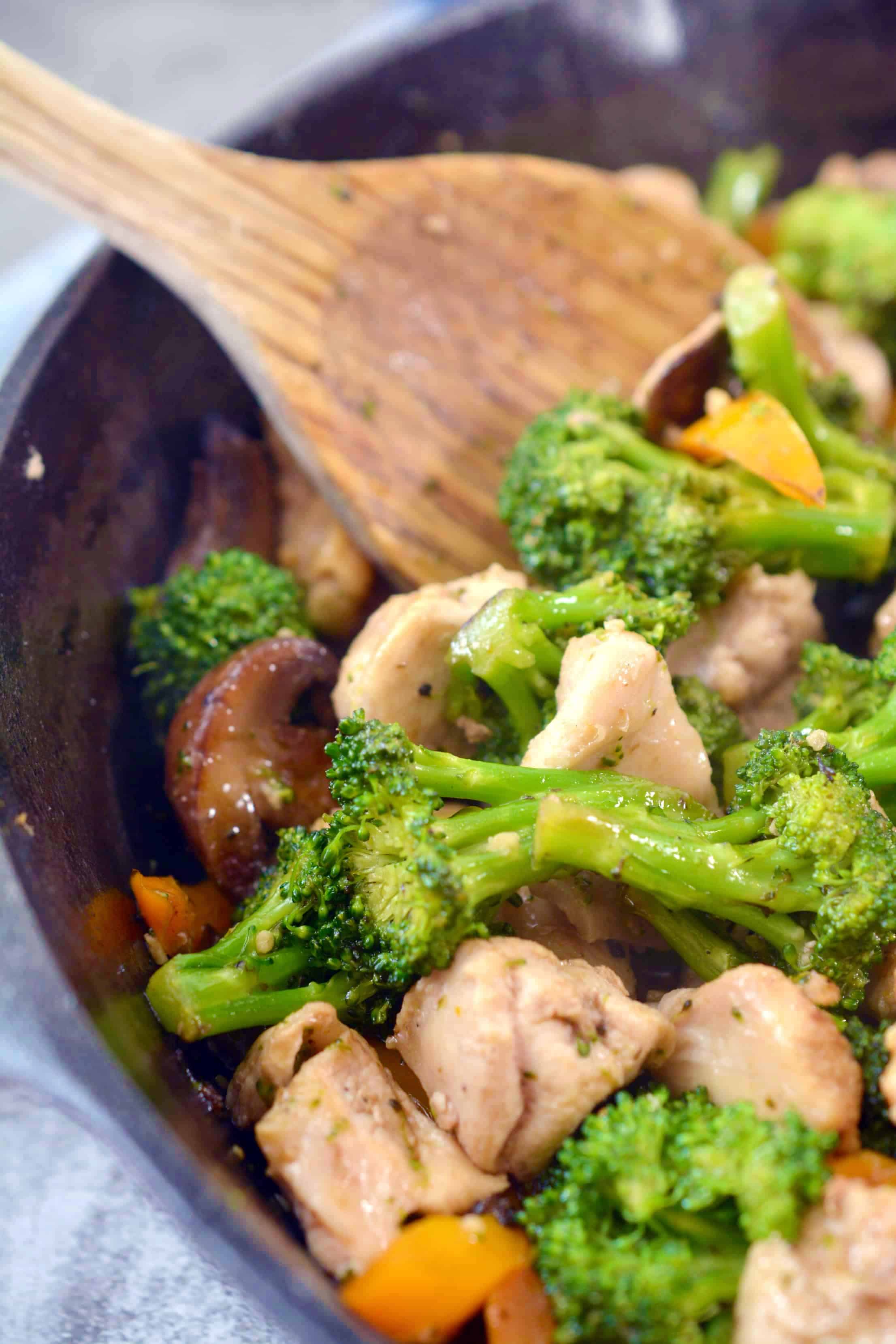 Garlic Chicken Stir Fry in a pan with wooden spoon