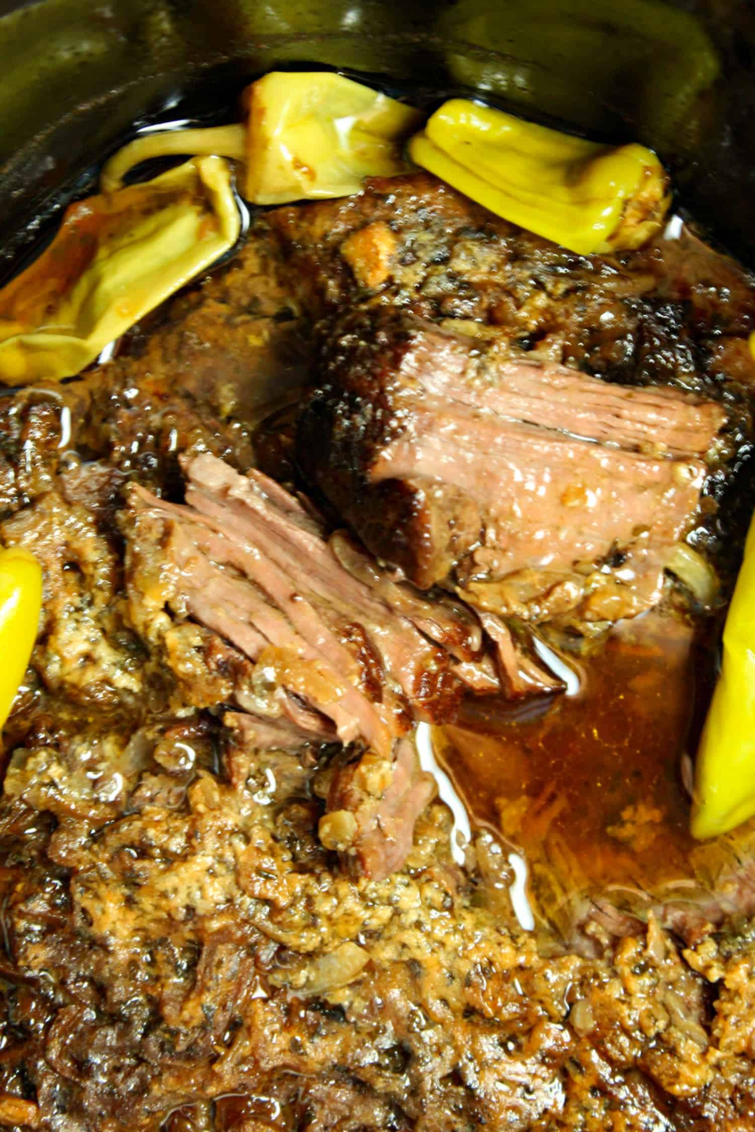 juicy pot roast with peppers around it