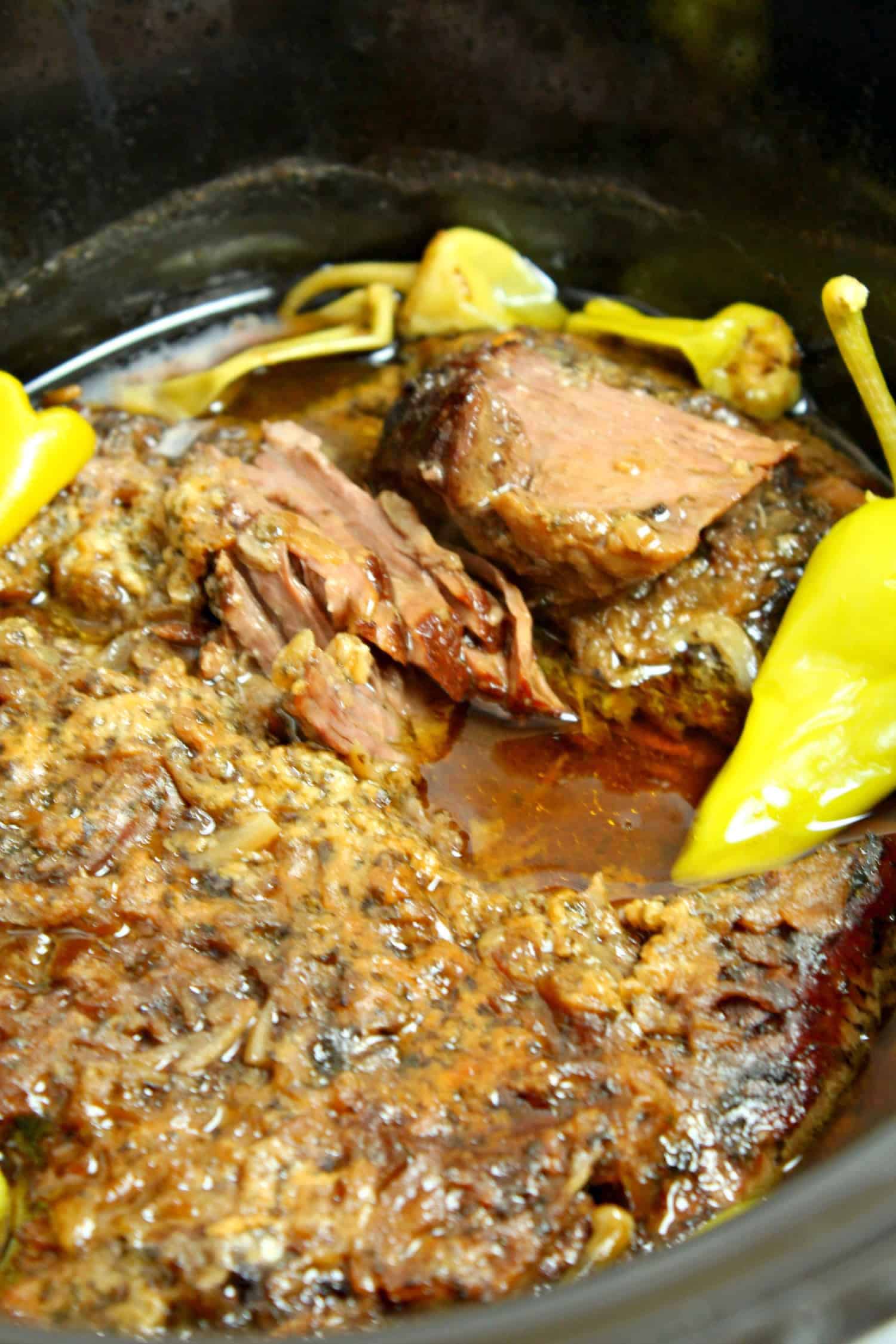 A cooked pot roast in slow cooker