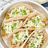 Overhead picture of prepared Instant pot chicken tacos on a silver platter