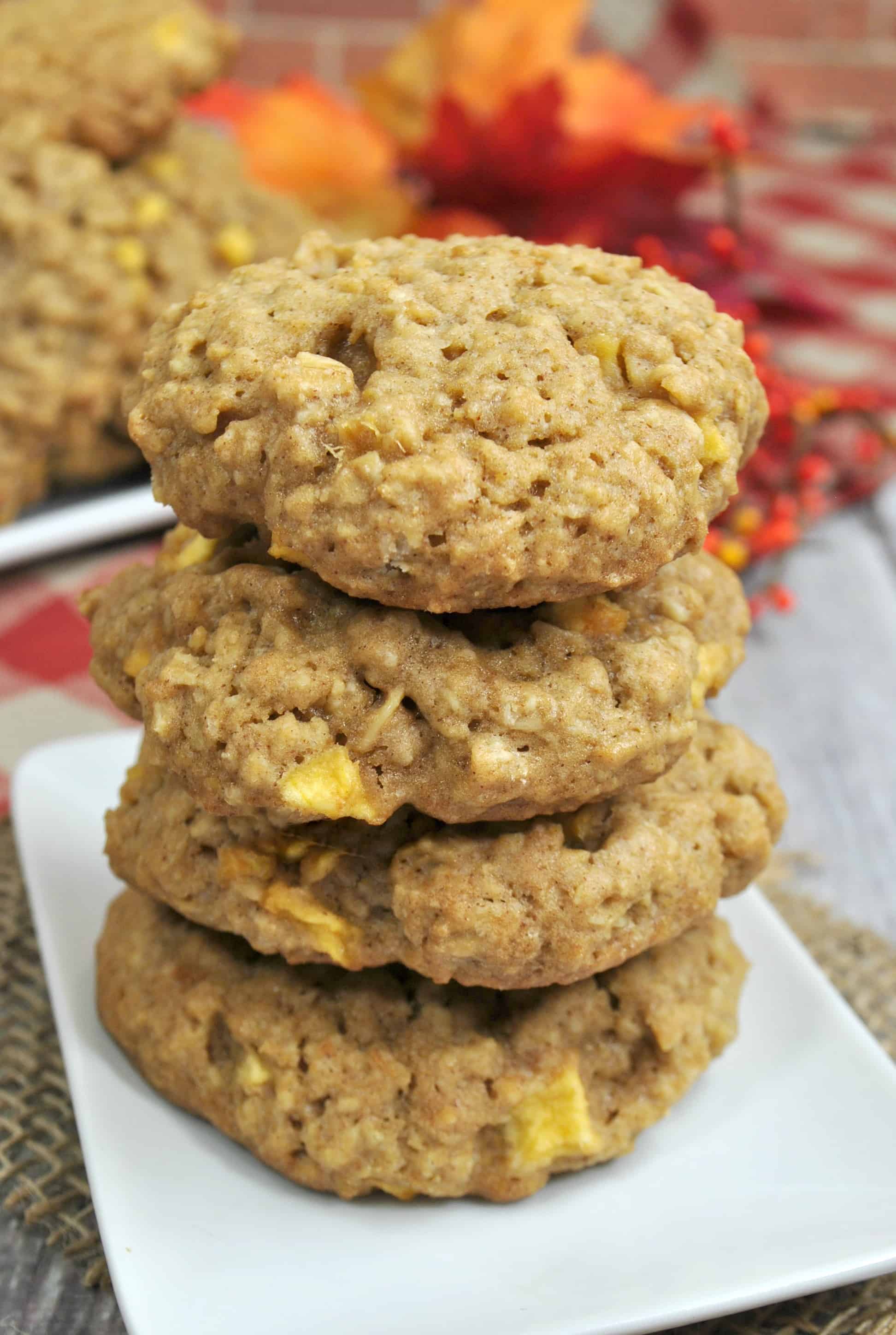 4 apple cinnamon cookies in a stack on a white plate