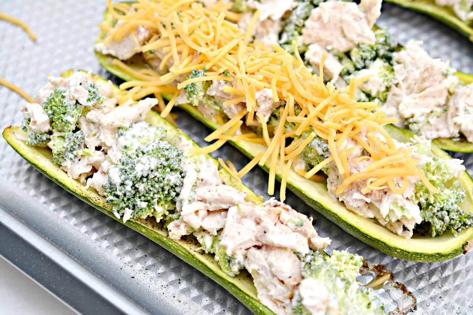add cheese to the top of zucchini boats
