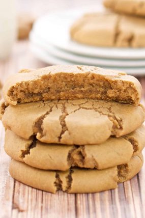 Brown Sugar Maple Cookies in a stack with one piece eaten off the top cookie