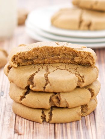 Brown Sugar Maple Cookies in a stack with one piece eaten off the top cookie