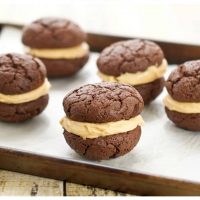 Close up picture of chocolate peanut butter whoopie pies recipe sitting on a baking sheet