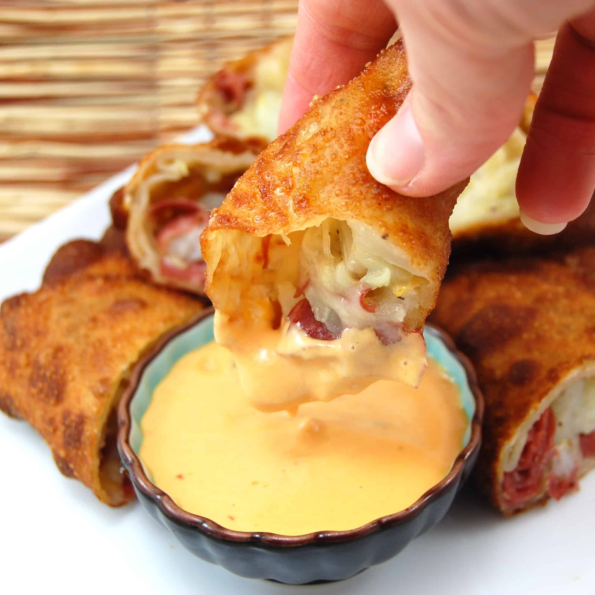 corned beef and cabbage eggroll dipped into thousand island dressing