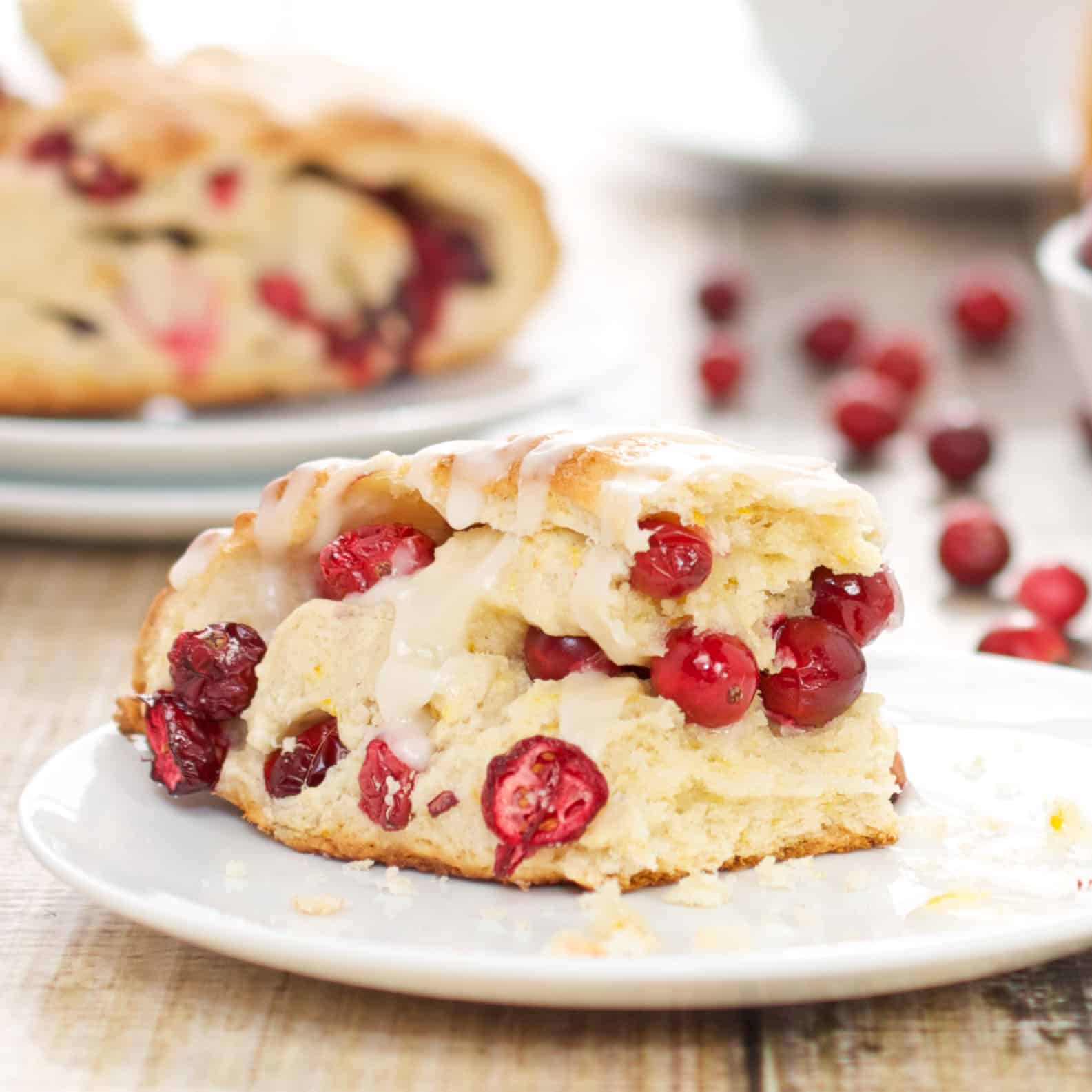 plate with cranberry scone and fresh cranberries