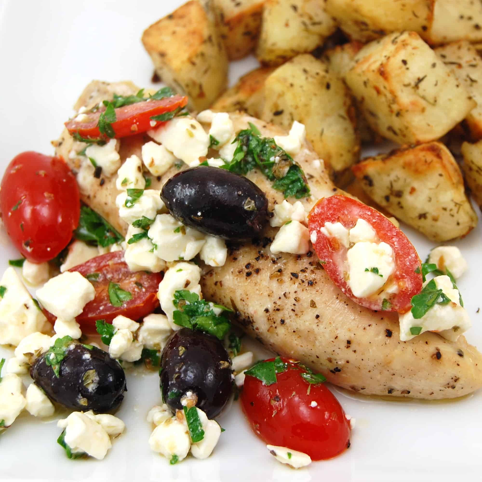 Greek chicken with feta cheese, tomatoes and olives with potatoes