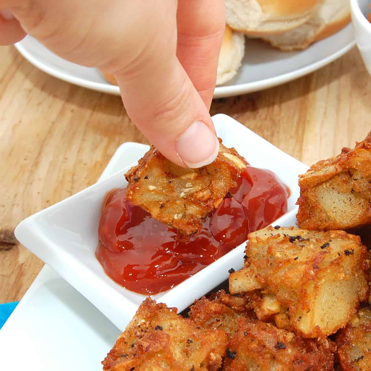 dipping potato tots in sauce