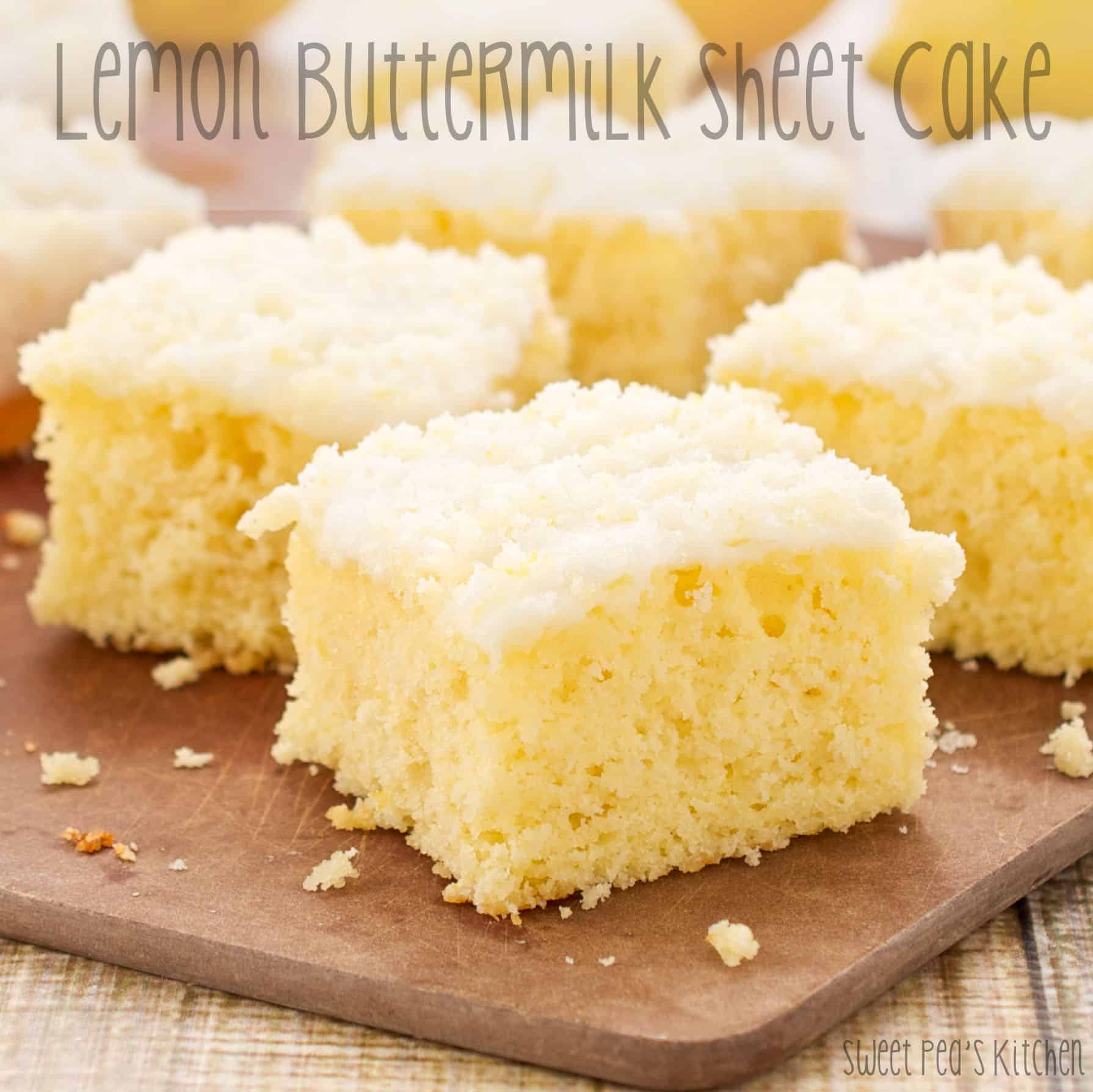 Close up picture of lemon buttermilk sheet cake sitting on wooden cutting board