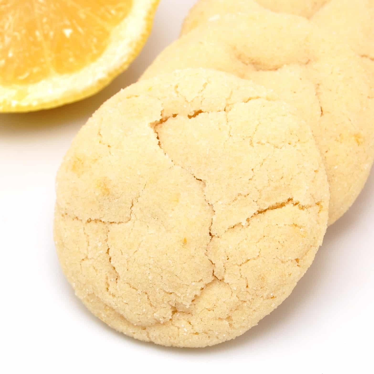 lemon sugar cookies with a sliced lemon