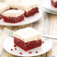 A single slice of red velvet brownies sitting on a white saucer