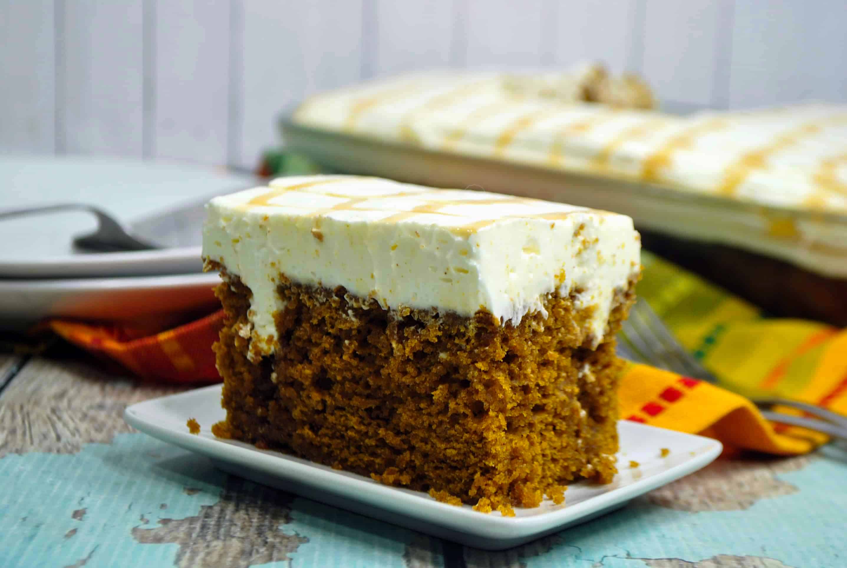 pumpkin poke cake with cream cheese whipped cream frosting