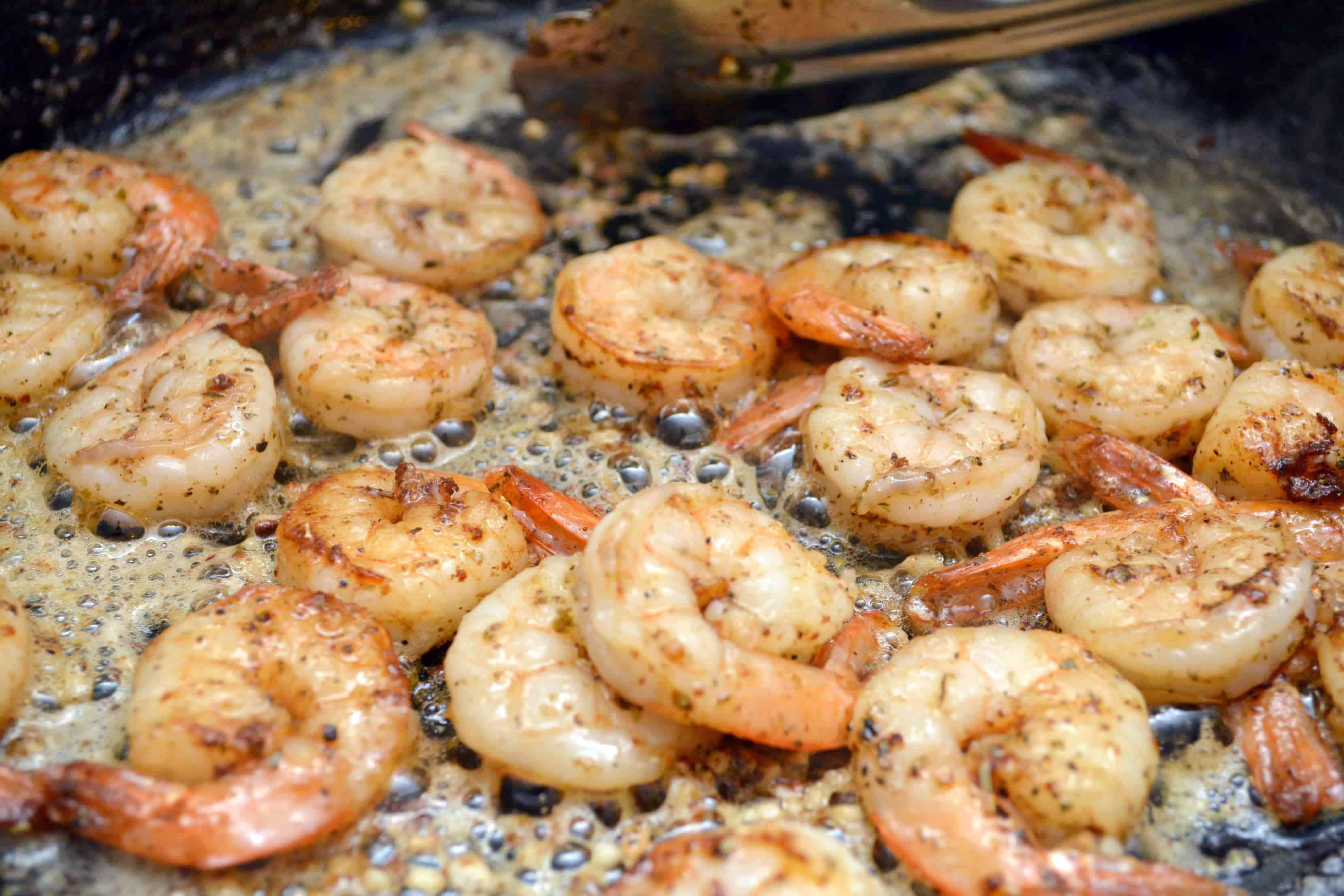 shrimp in a pan with lemon garlic butter sauce