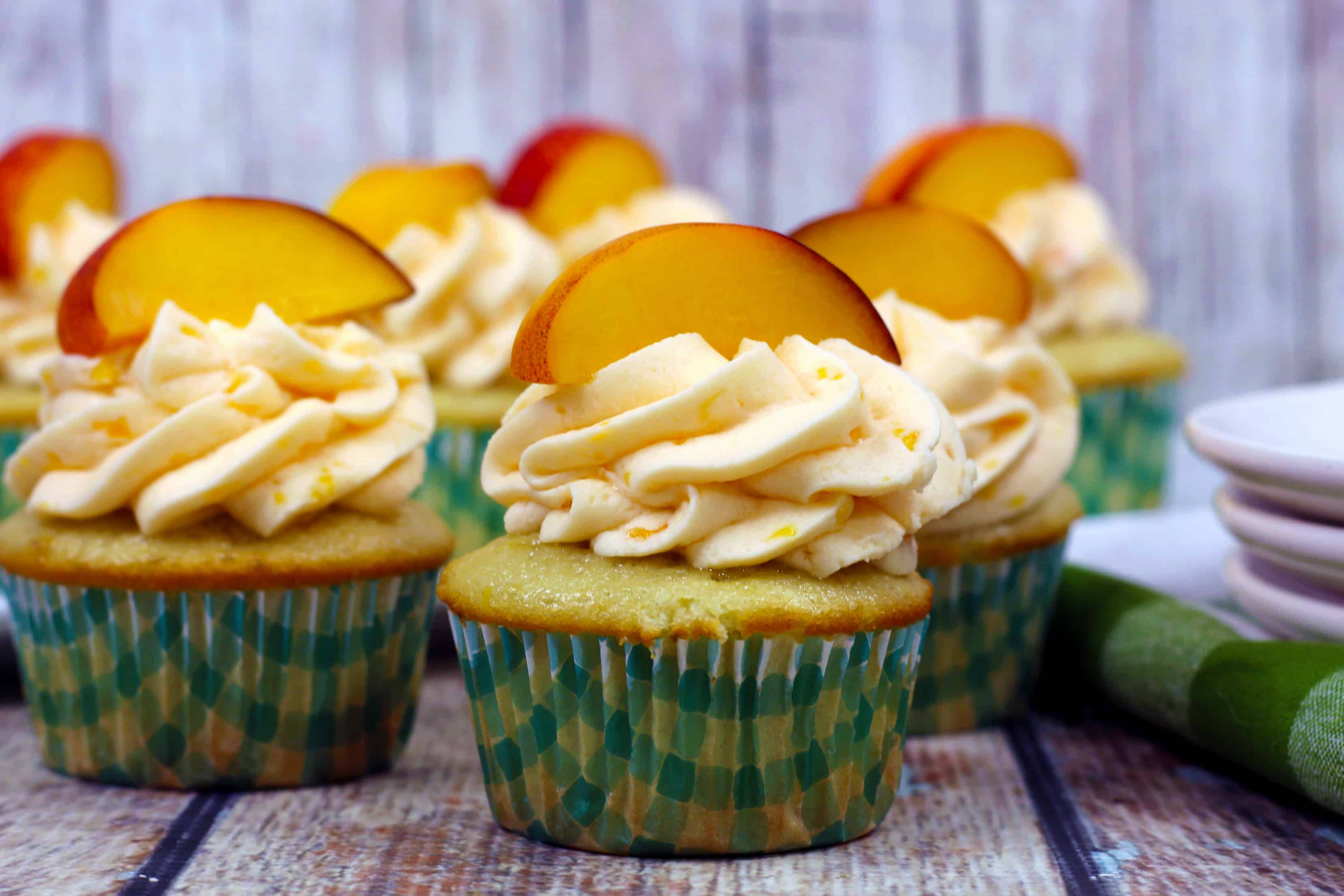 delicious peach cupcakes on a white plate