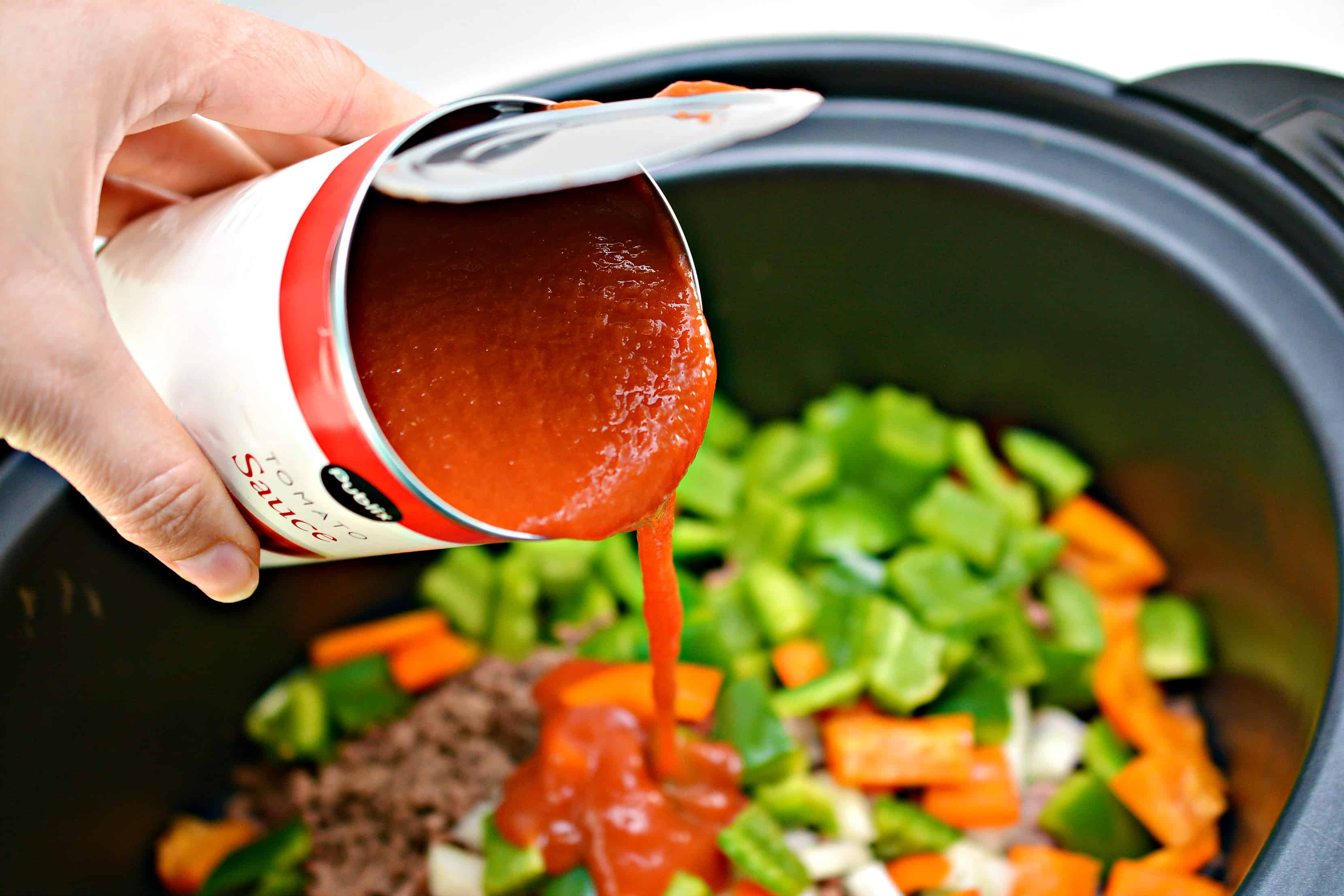 pouring tomatoe sauce