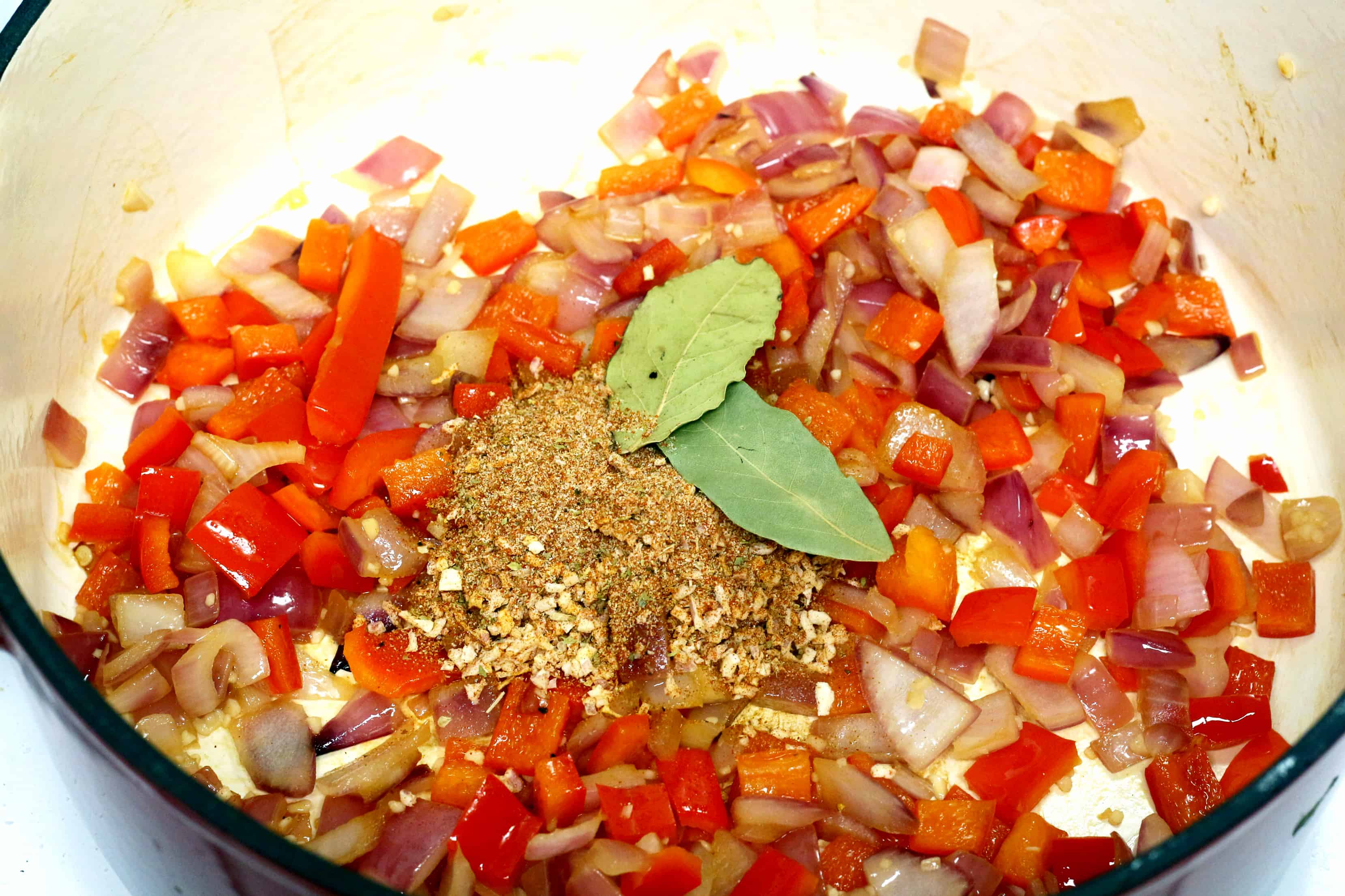 onions, peppers and spices in a pot