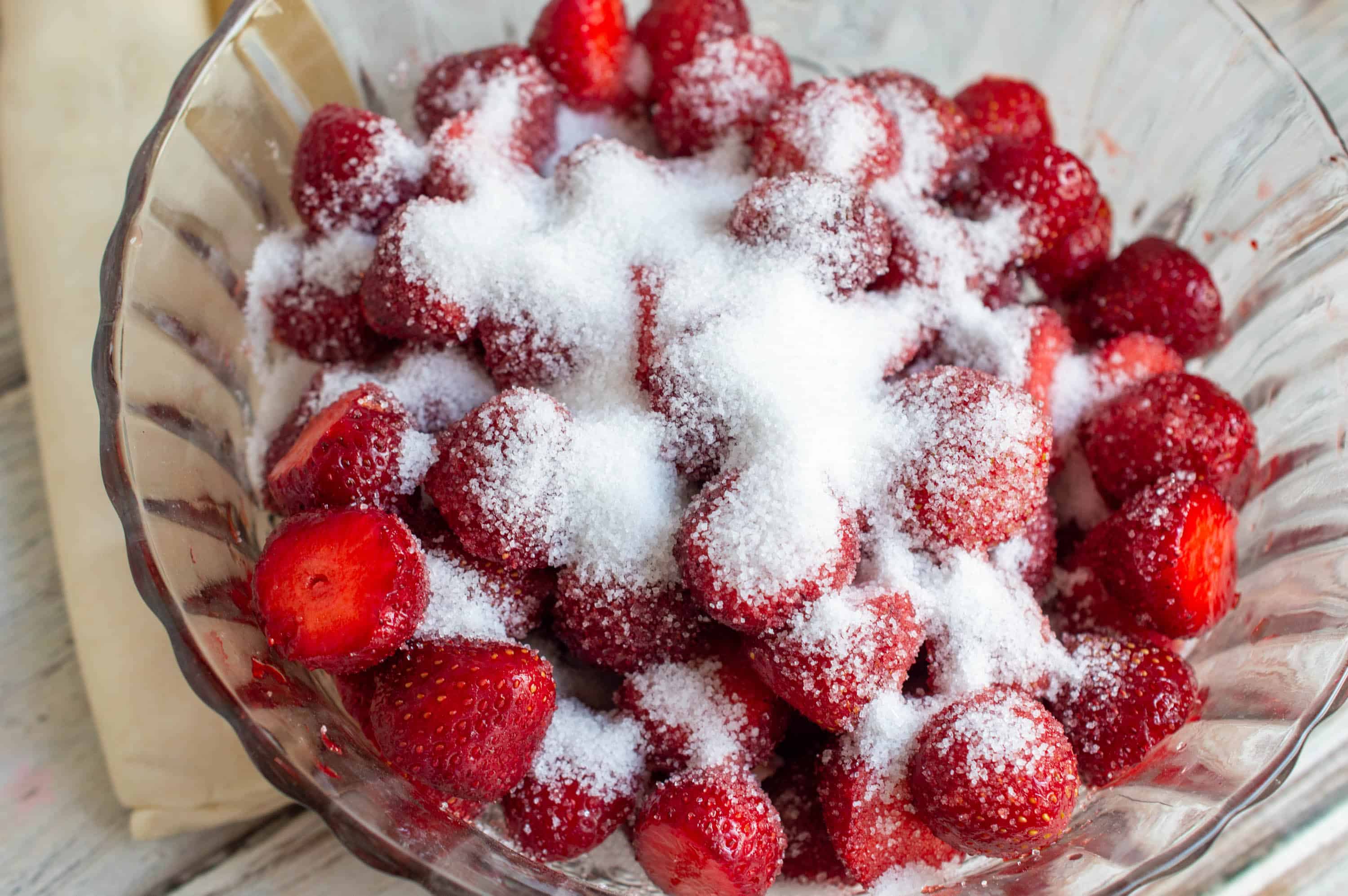 sugar and strawberries in a bowl