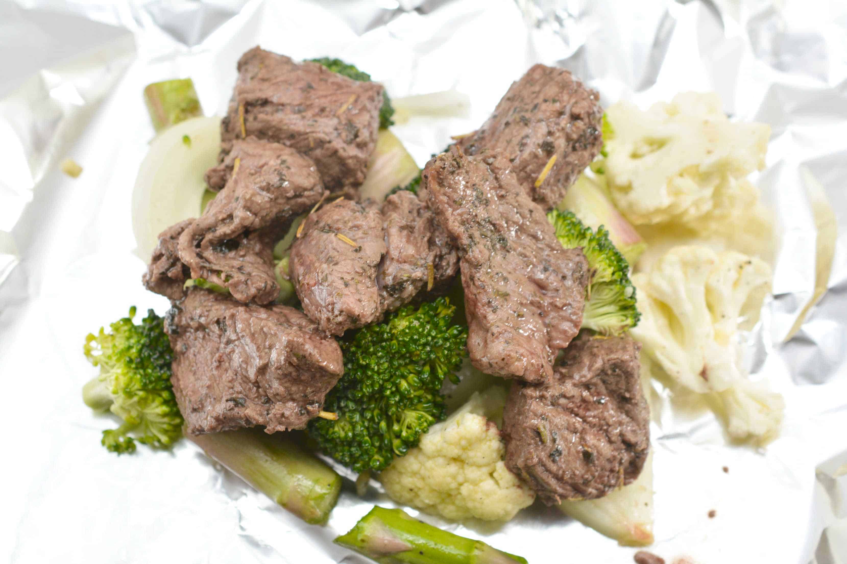 cooked steak and vegetables in foil