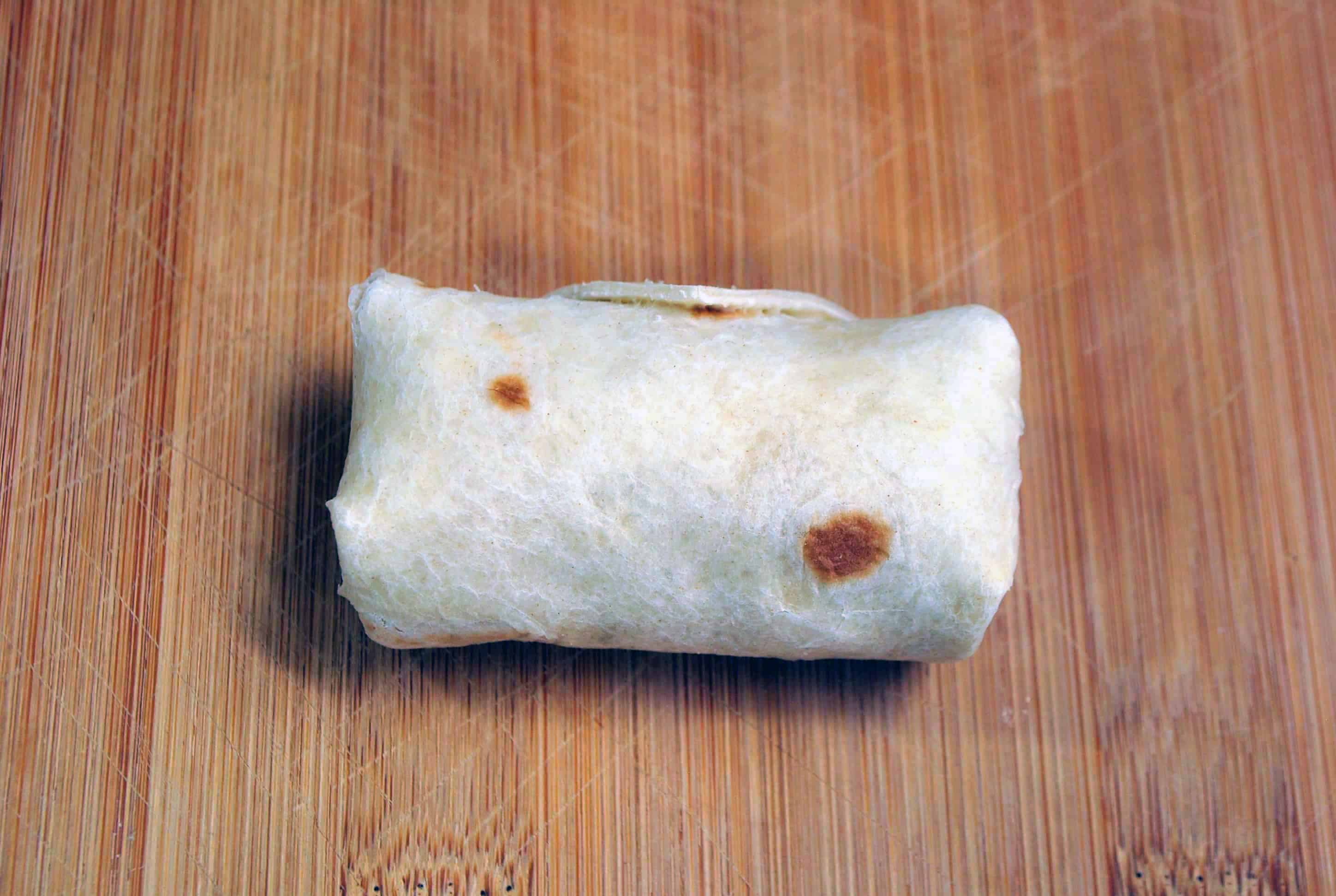 rolled tortilla with chicken mixture inside