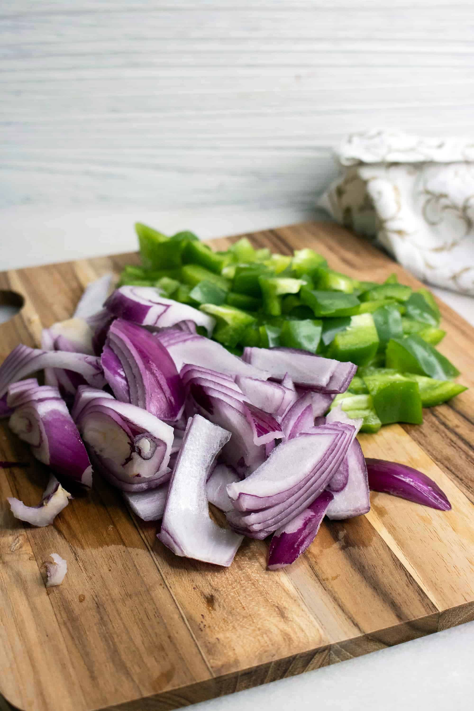 onions and peppers on a cutting board