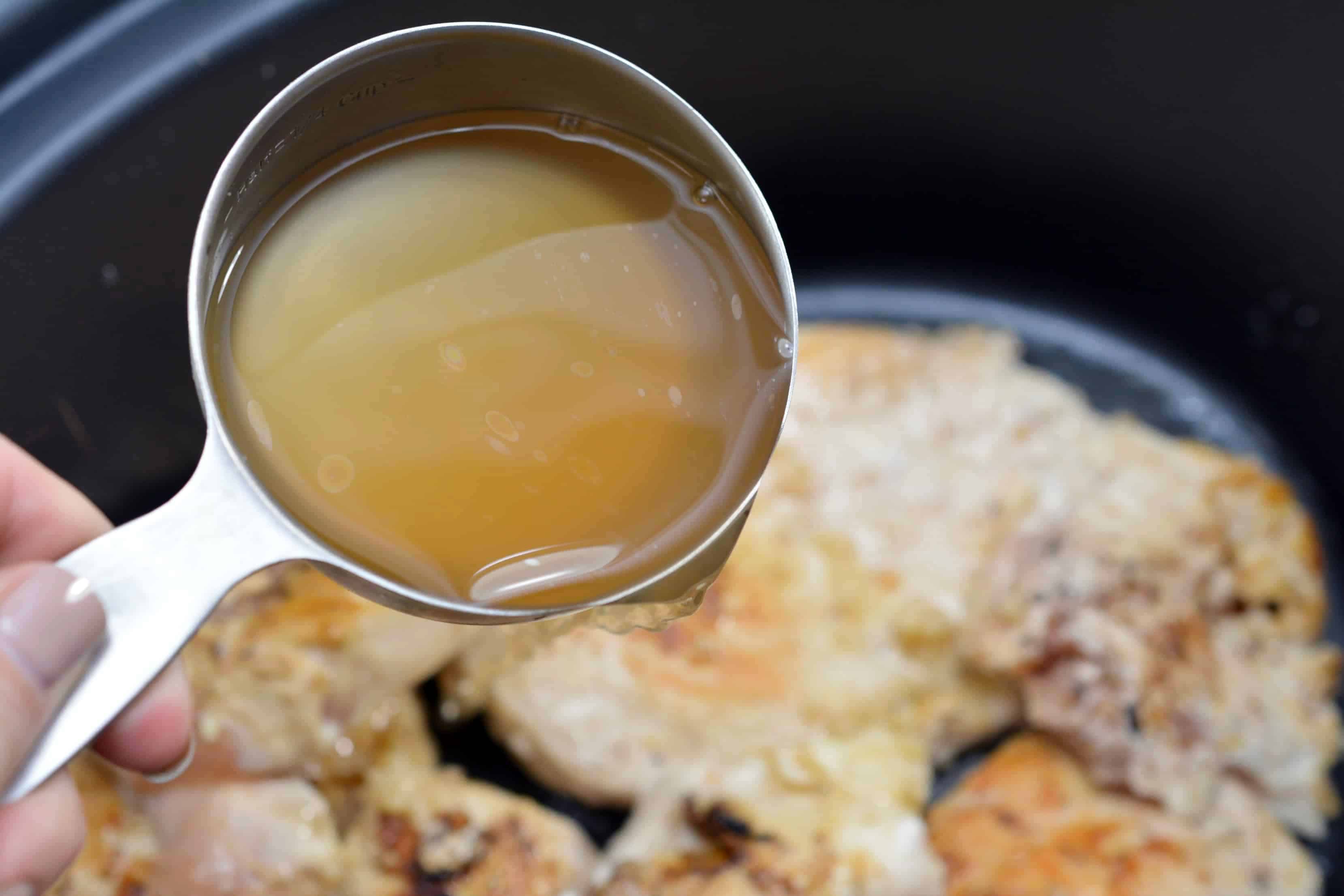 Pour chicken broth over the chicken