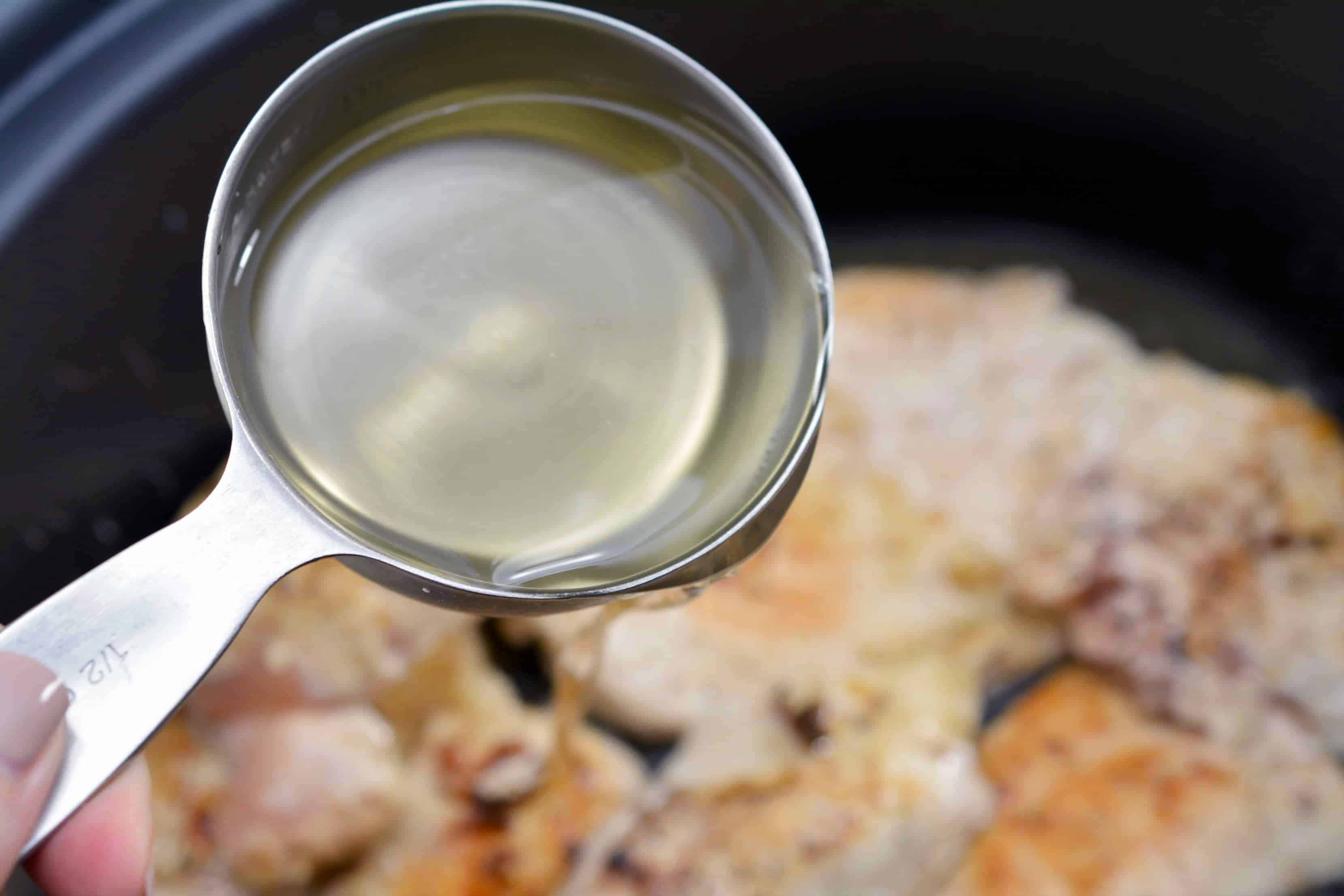 add white wine to the chicken