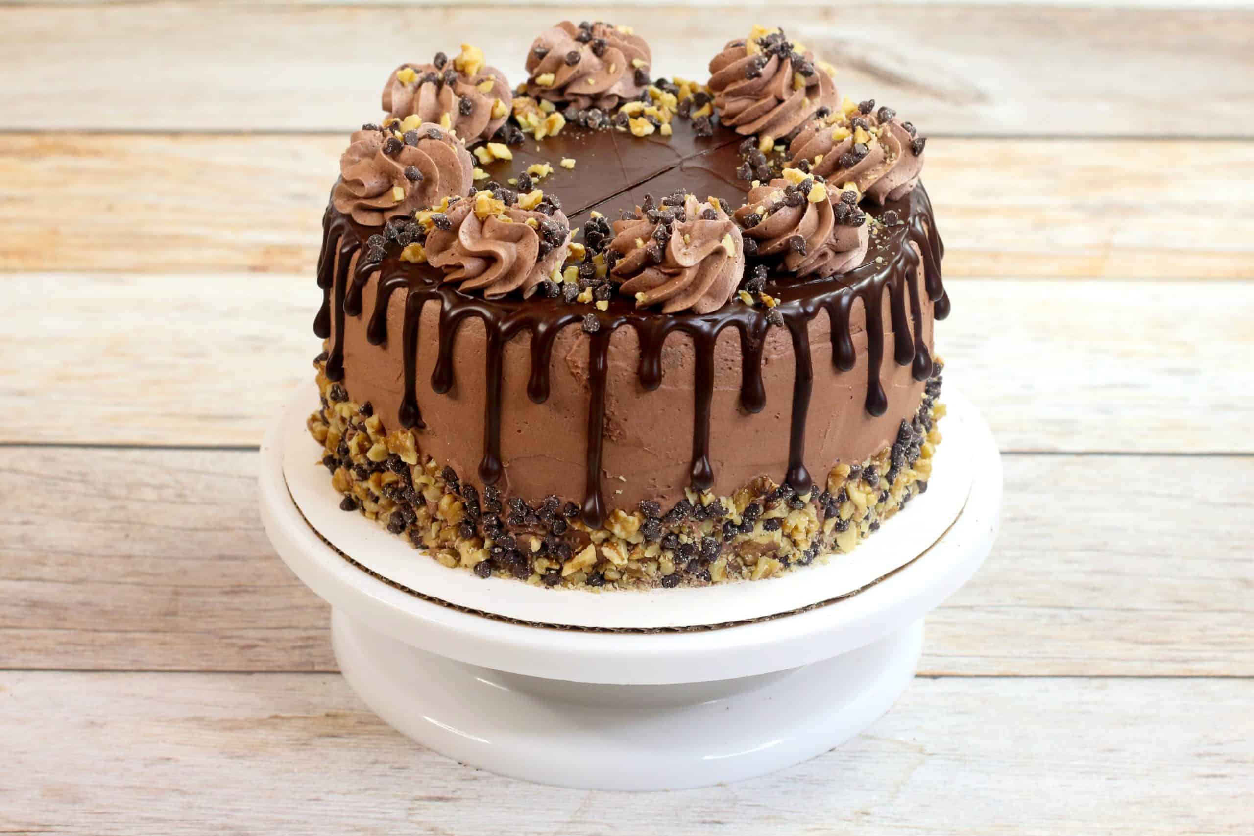 chocolate fudge cake with decorations on a cake board 