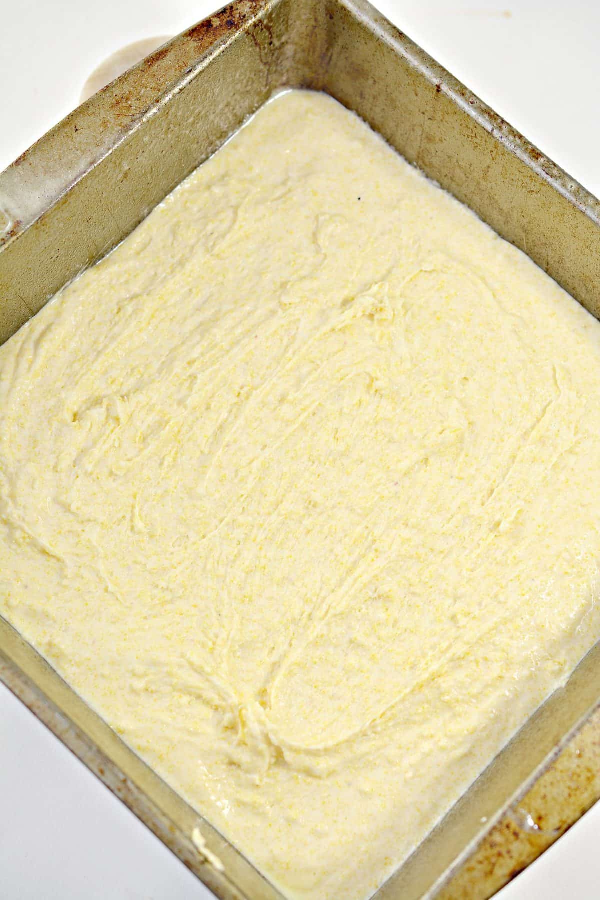 Prepare the cornbread mix according to the directions on the package, and place it into a well-greased 9x9 baking dish.