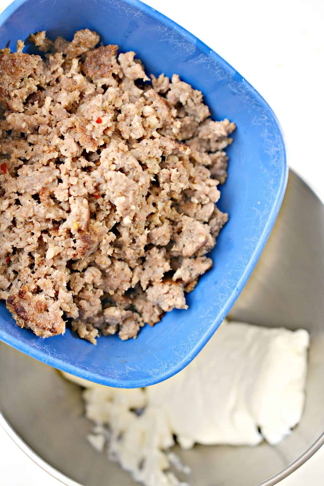 Add the cooled ground sausage to a mixing bowl with the cream cheese.
