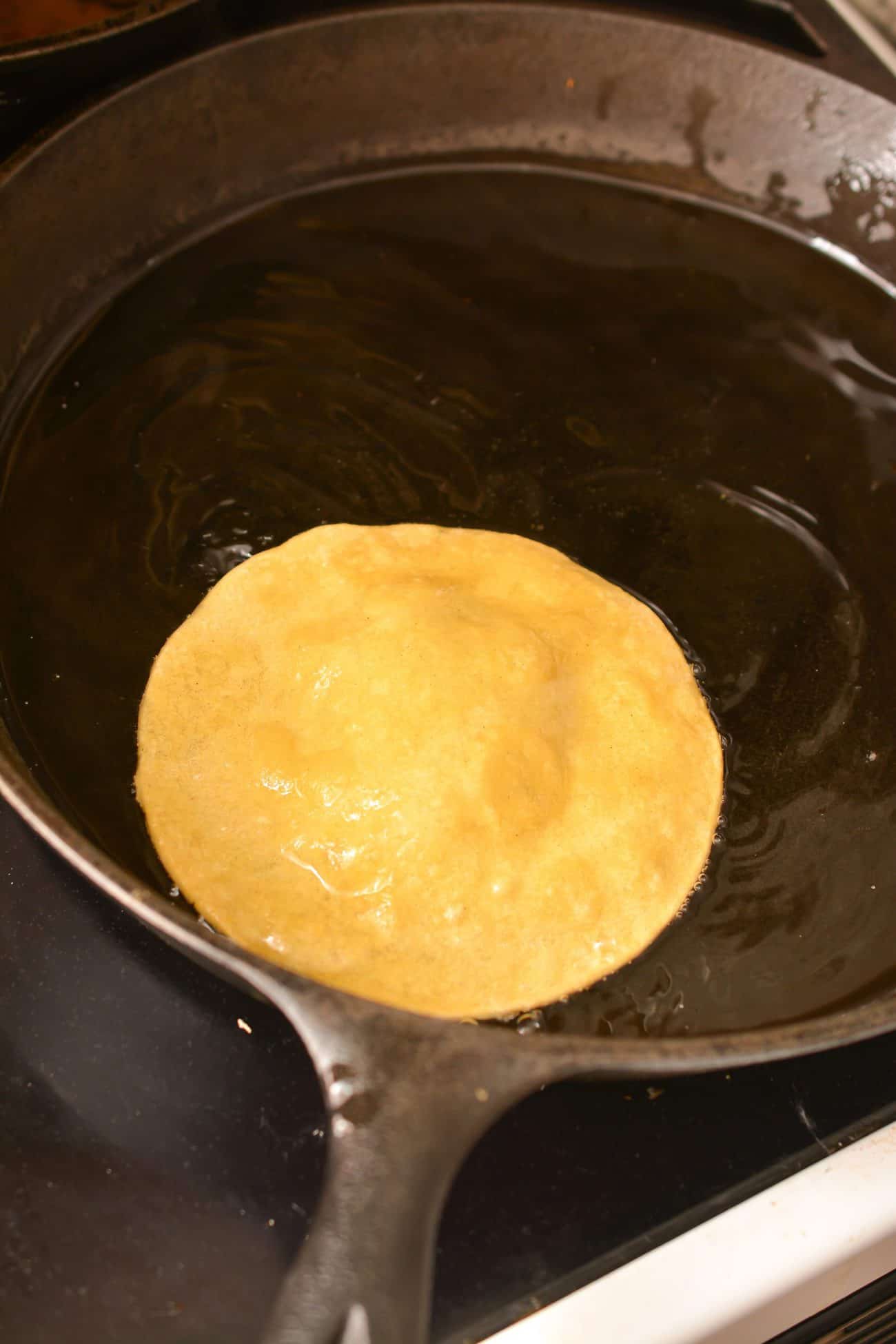 Heat the oil in a skillet over medium heat on the stove. Fry the tortillas for a minute or two on each side until golden, and then remove to drain on a paper towel-lined rack.