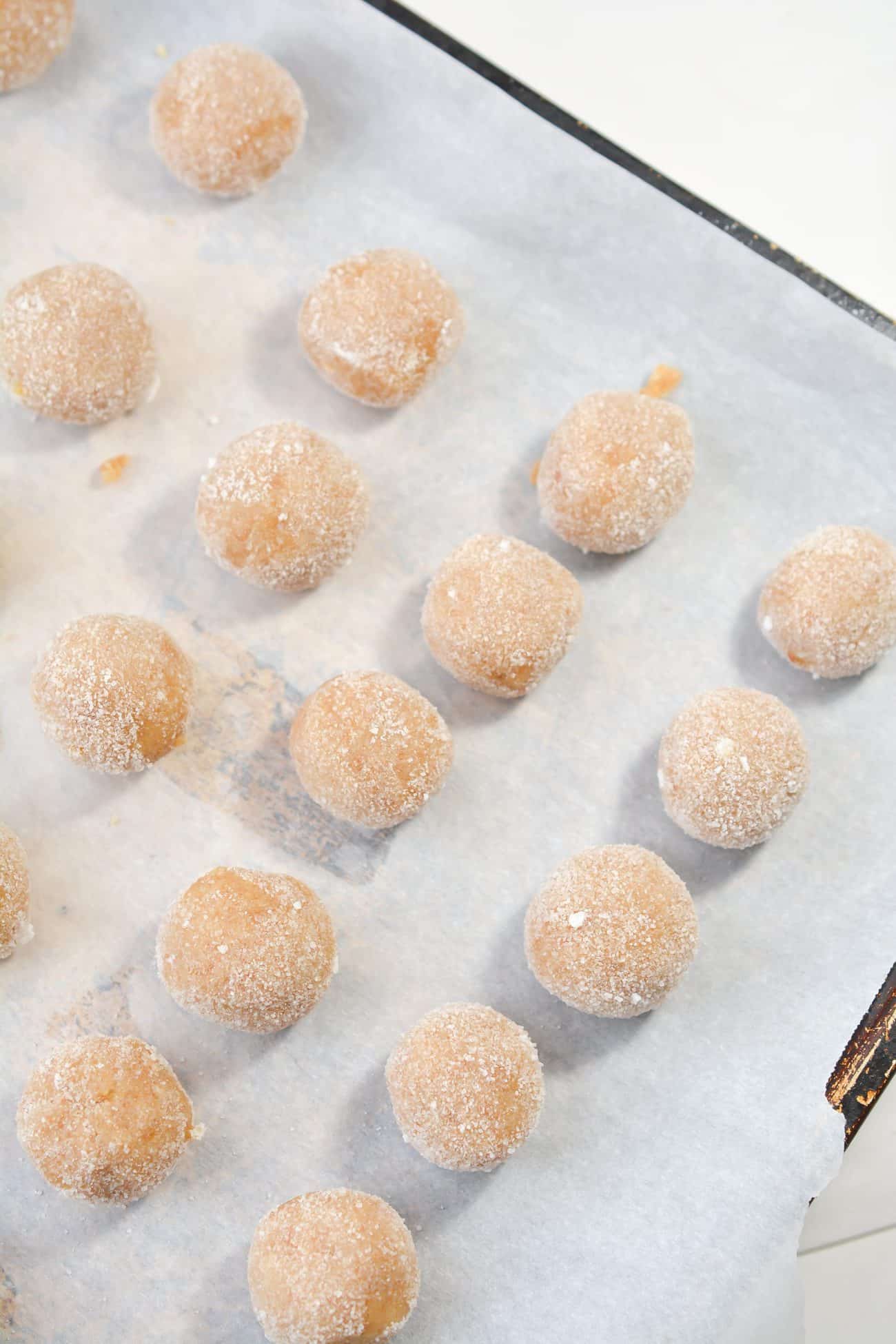 Form the dough into 3 dozen evenly sized balls and roll them to coat them in granulated sugar.