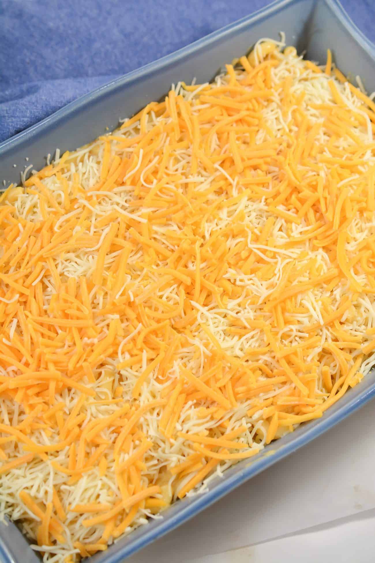 Pour the mixture into a well-greased 9x13 baking dish and top with the remaining 1 cup of each of the shredded cheeses.