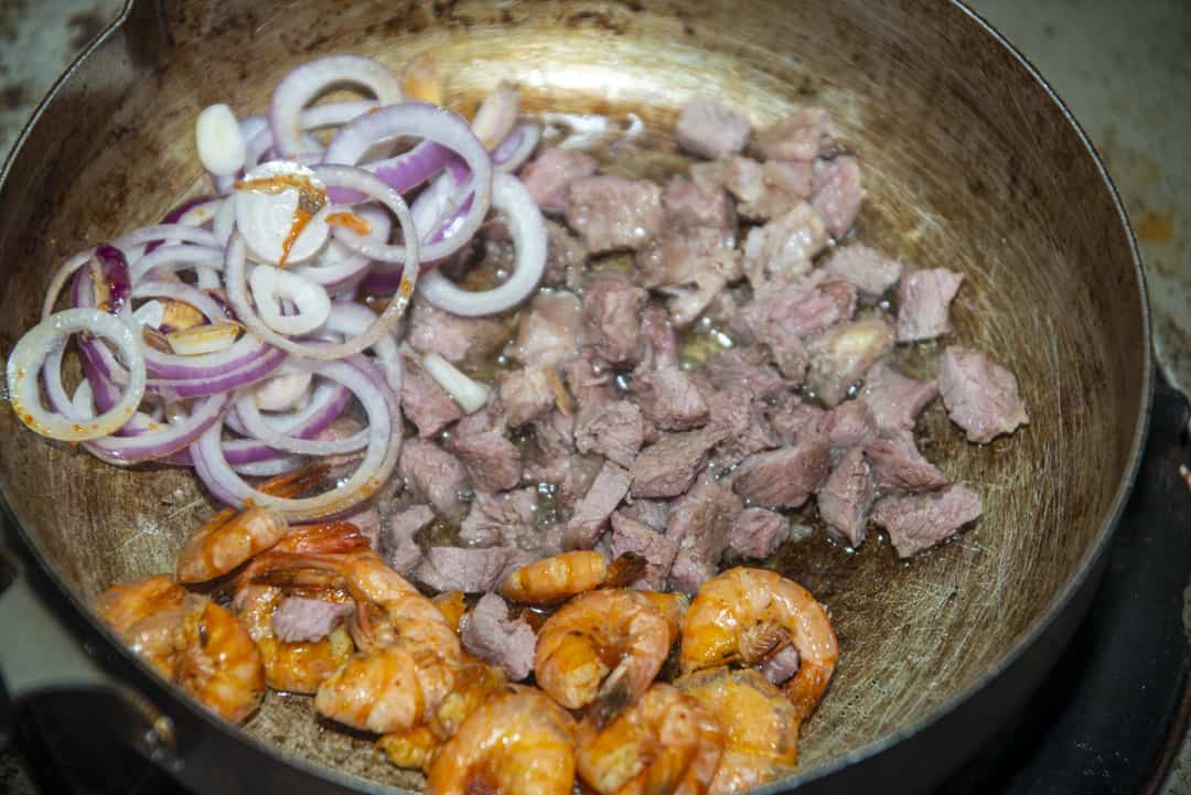 Add shrimp and steak back to the pan with fajita seasonings. Over low heat, cook for 1 additional minute.