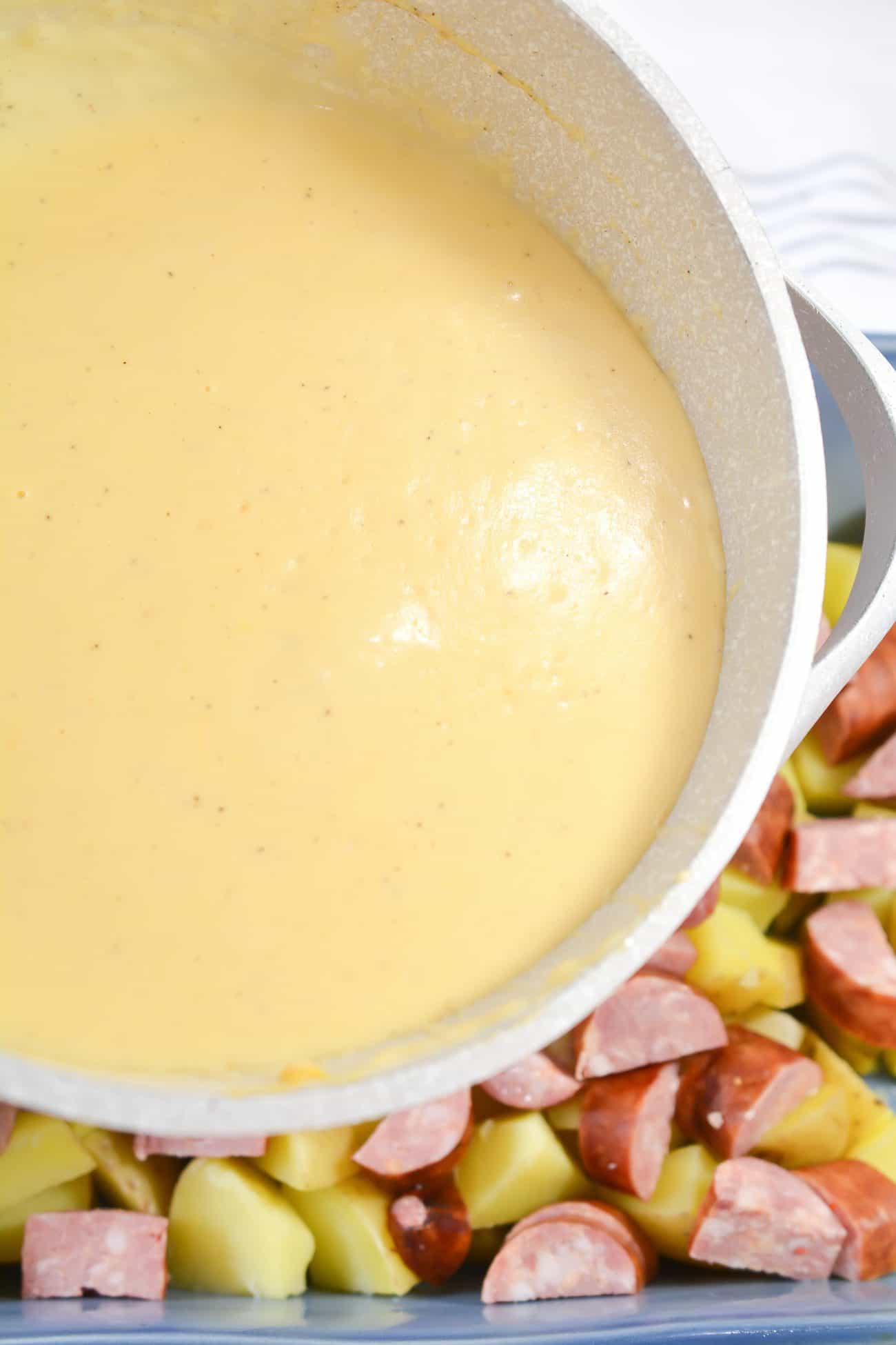 Pour the cheese sauce over the sausage and potatoes, and stir to combine.